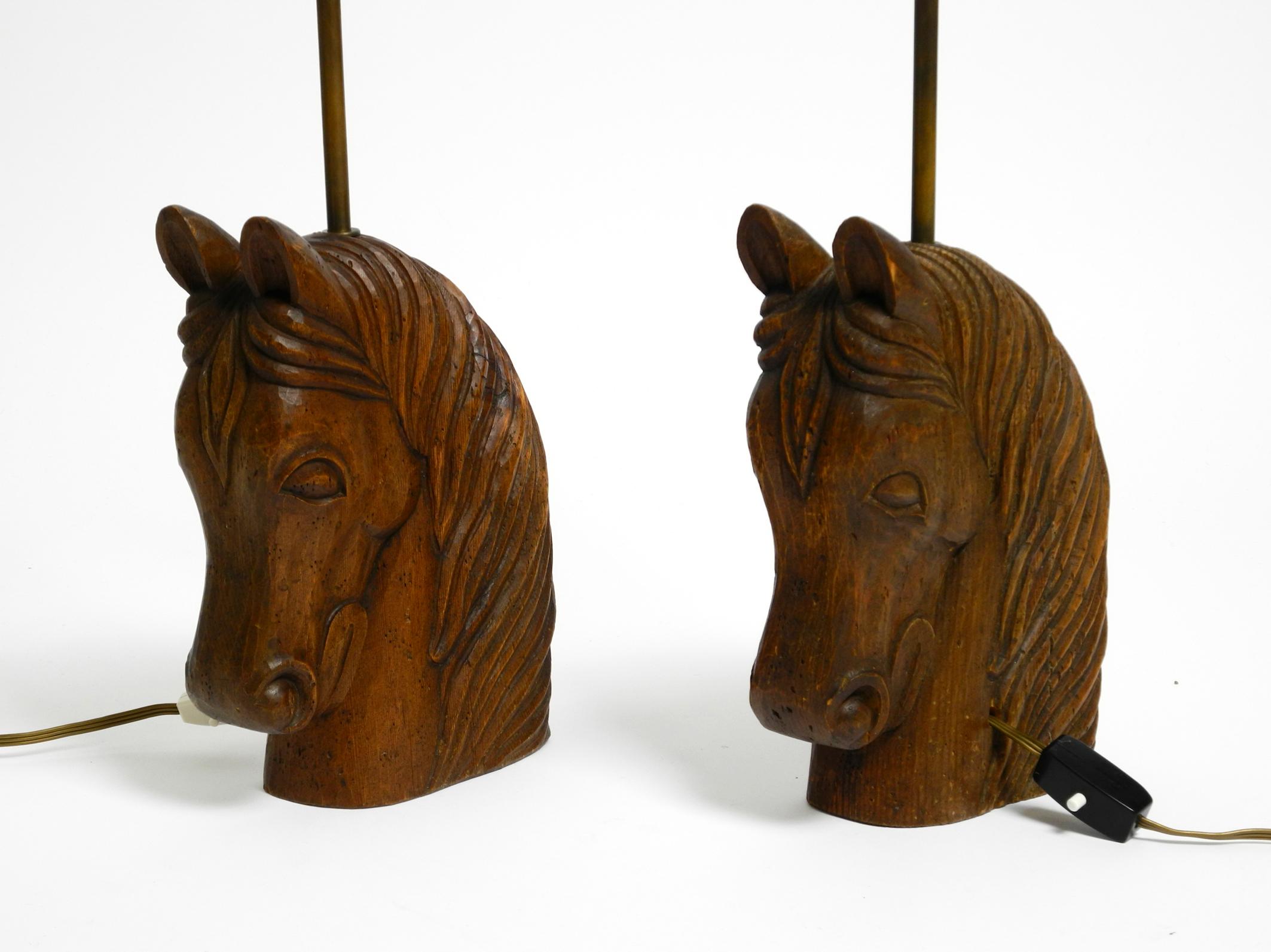 Pair of very decorative large 1950's horse head table lamps. Made in Spain.
The table lamps are made of hand-carved Spanish pine wood, stained in dark brown.
Each lamp is unique but identical in size.
Beautiful with a fantastic patina and traces of