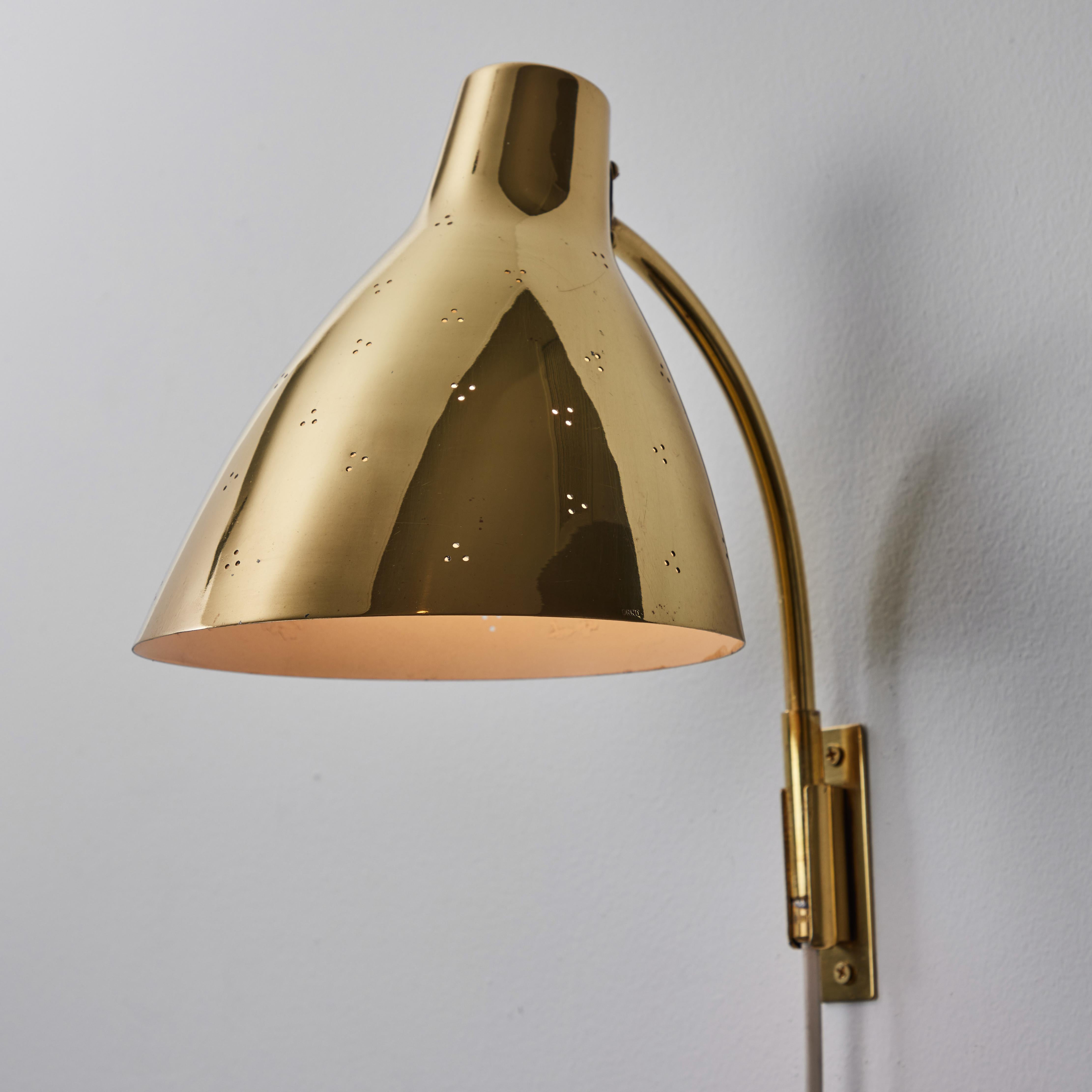 Pair of Large 1950s Lisa Johansson Pape #3055 Brass Wall Lamps for Stockmann. A highly sculptural pair of wall lamps executed in perforated brass.

Price is for the pair. 

A contemporary of Paavo Tynell, the refined work of Lisa Johansson-Pape has