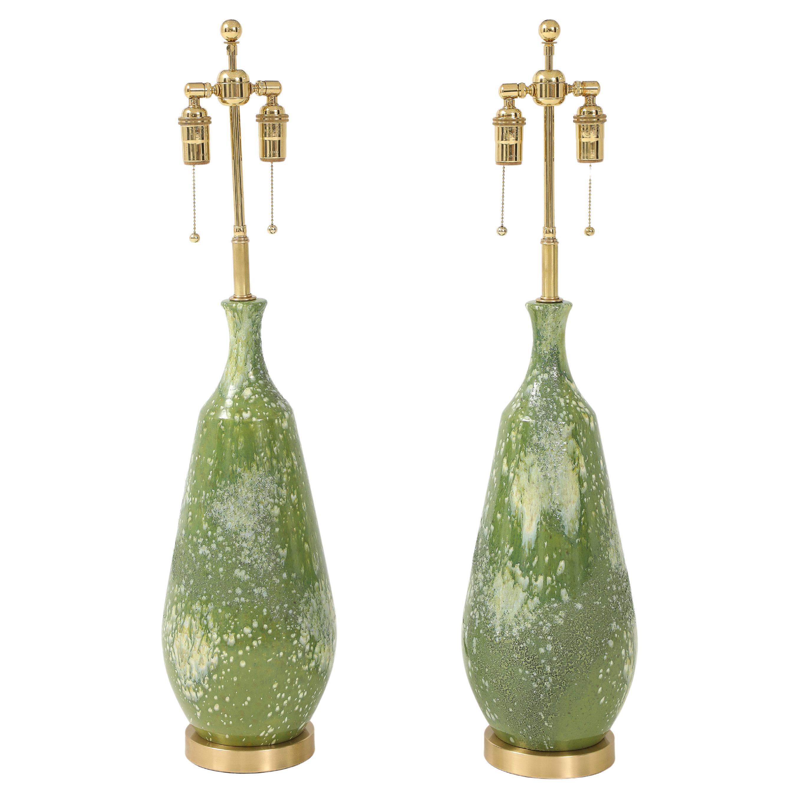 Paar große Keramiklampen mit einer Avocado-grünen, strukturierten Glasur.
Die Lampen wurden neu verkabelt und mit verstellbaren, polierten Messingdoppelbündeln versehen.
und Seidenkordeln aus Rayon.
Jede Fassung fasst bis zu 60 Watt / 120 Watt pro