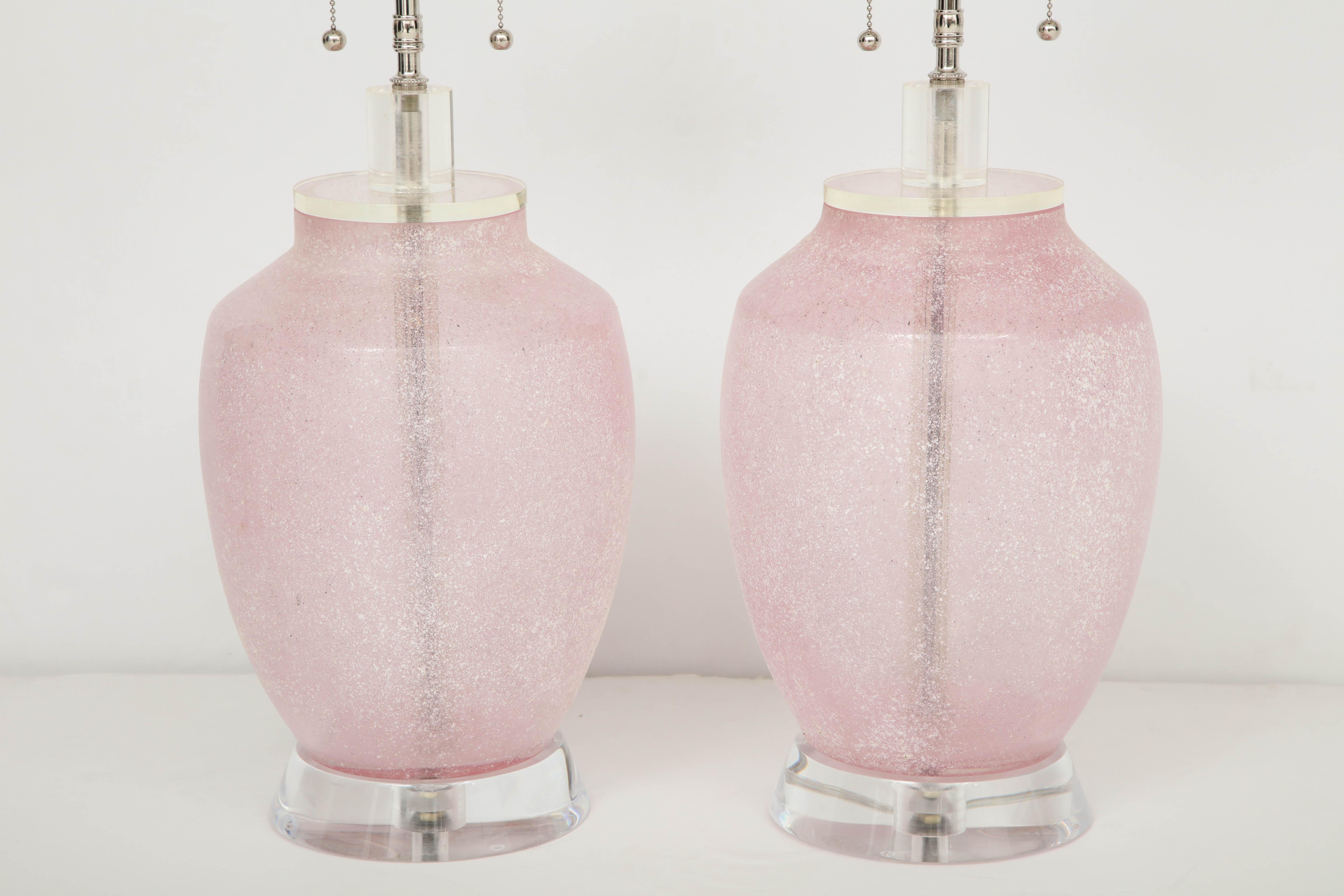 Pair of large 1960s lamps by Cenedese.
The pink lamp bodies have a frosted textured finish and are mounted on thick Lucite bases.
The lamps have been newly rewired for the US with polished nickel double clusters that take standard US light bulbs.