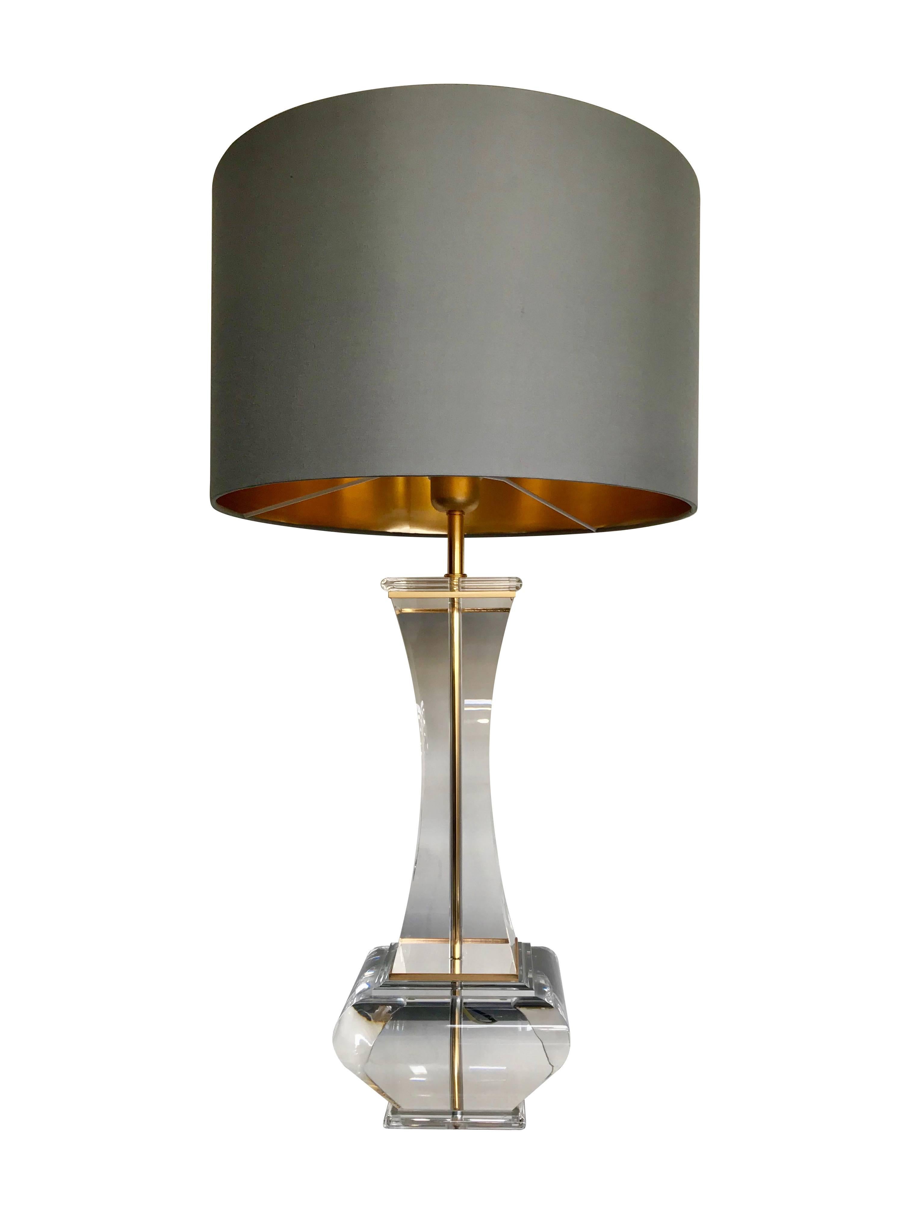 A pair of large Lucite lamps with gilt metal trim detailing around the top and base. With new bespoke circular shades in slate grey with gold linings. Re wired with new fittings, antique cord flex and PAT tested. Height is listed without shade 56cm