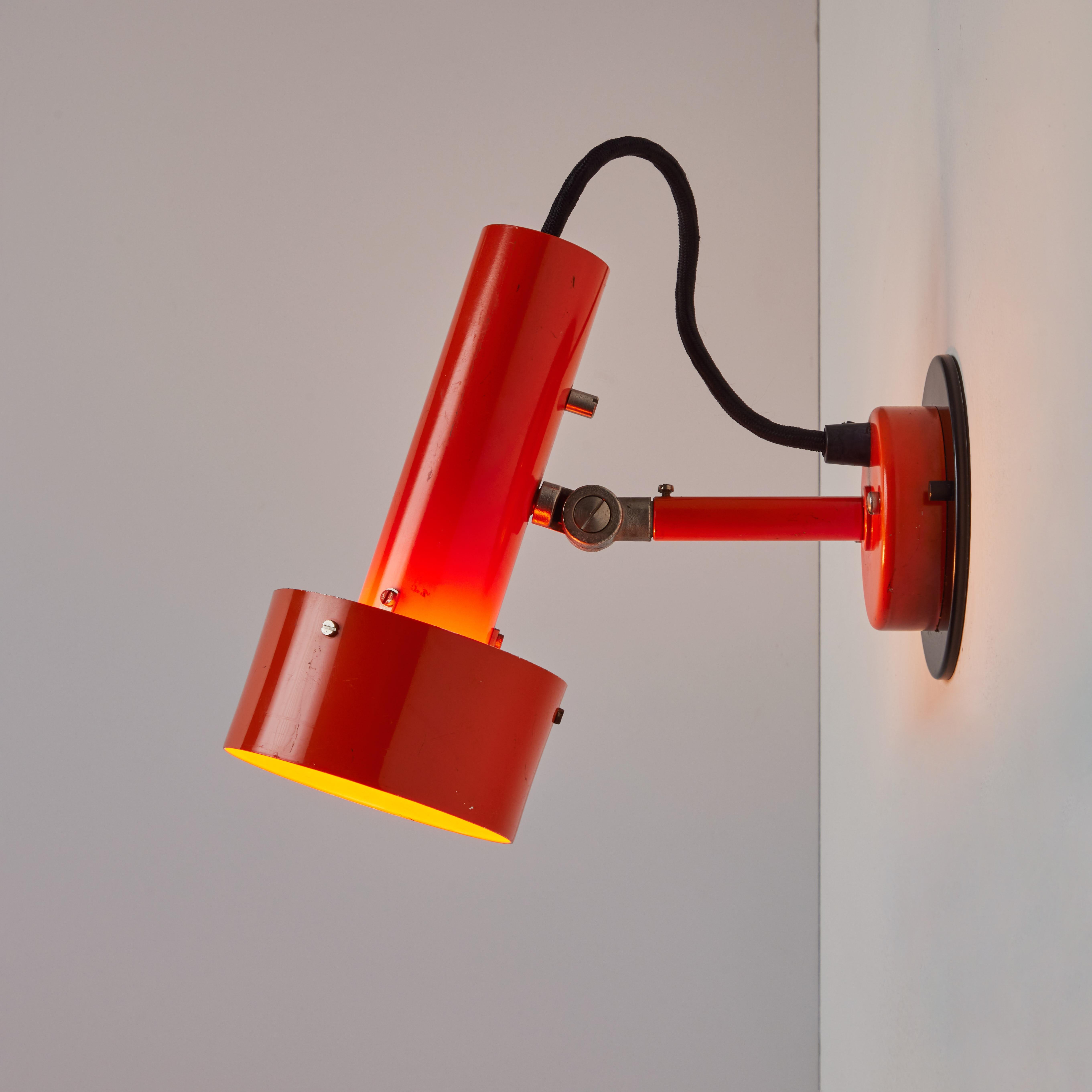 Pair of Large 1970s Orange Sconces for Nordisk Solar.

Executed in bright orange painted metal shade with black backplate which has been professionally modified for mounting over standard US j-box. A very architectural and refined wall lamp