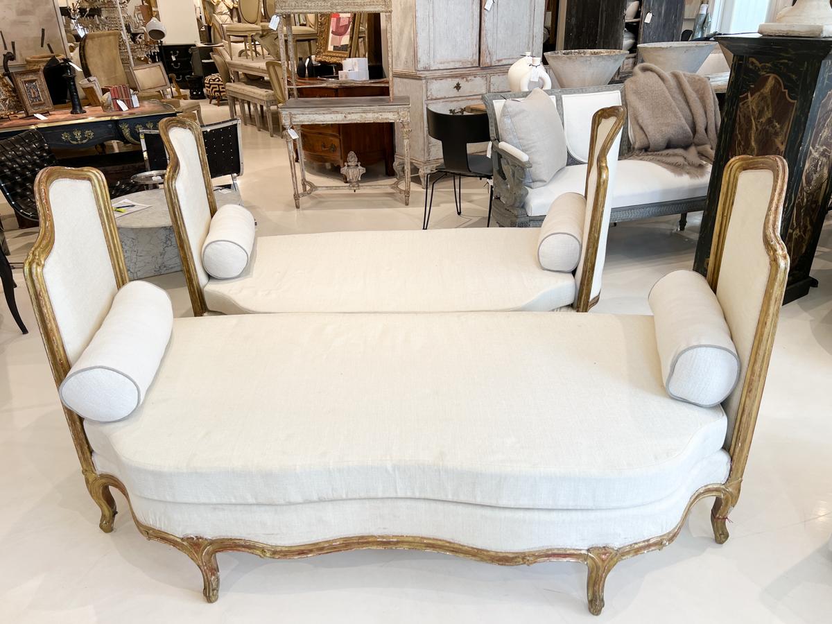 A very unusual pair of banquettes. One is slightly longer than the other, otherwise, they are identical. High curved and gilded sides and undulating seats make these benches very alluring.

Dimensions:
 39
