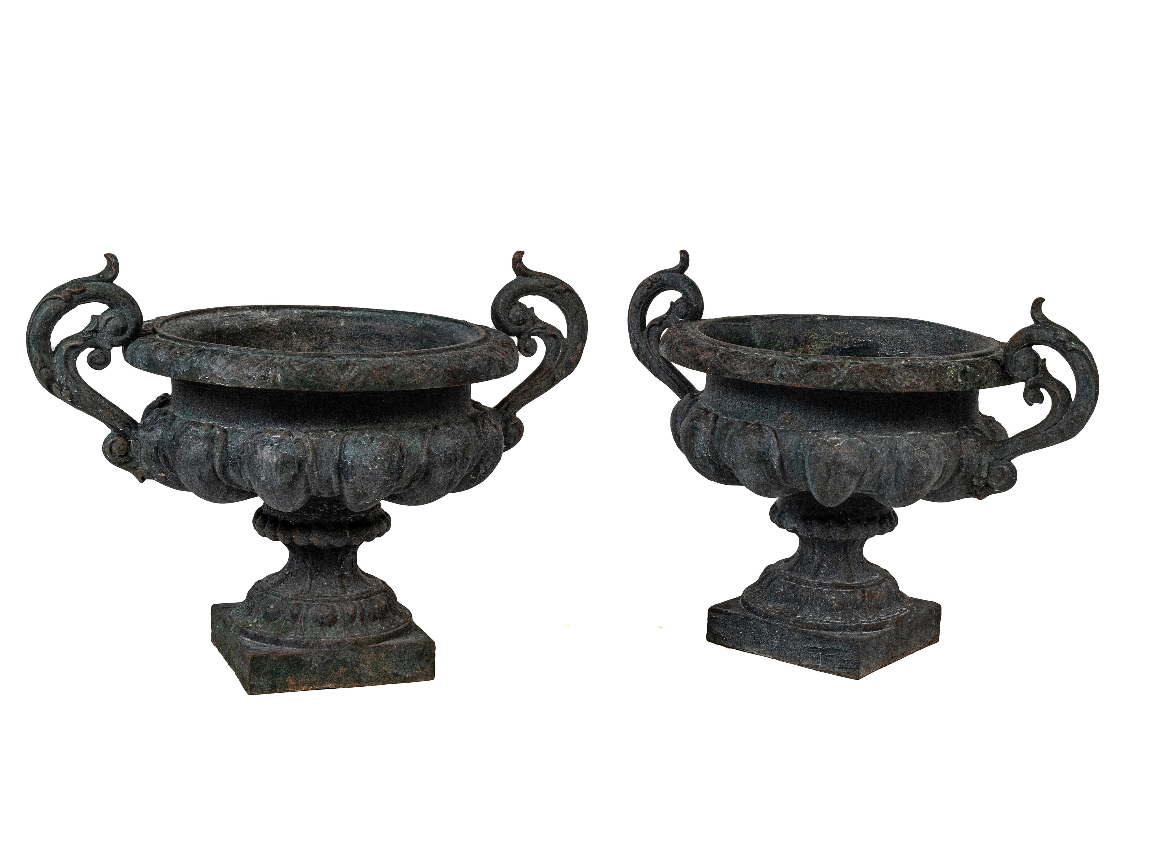 Pair of 19th Century French Napoleon III Garden Urns.  This is an extra large pair of 19th century French cast iron with large decorative exaggerated handles.  This pair would work well in an interior or exterior on a terrace or garden setting or a