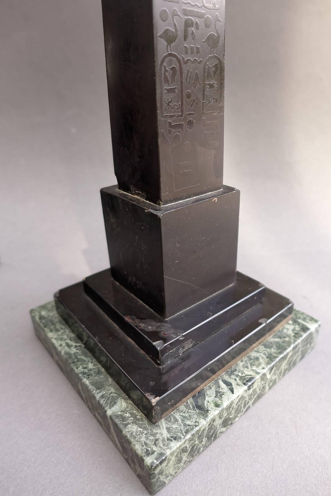 A very attractive pair of Italian Grand Tour black marble obelisks. Detailed hieroglyphics to the front side, on a green marble plinth. Minor corner chips to both obelisks, otherwise nice, original condition. 

The Grand Tour was an traditional