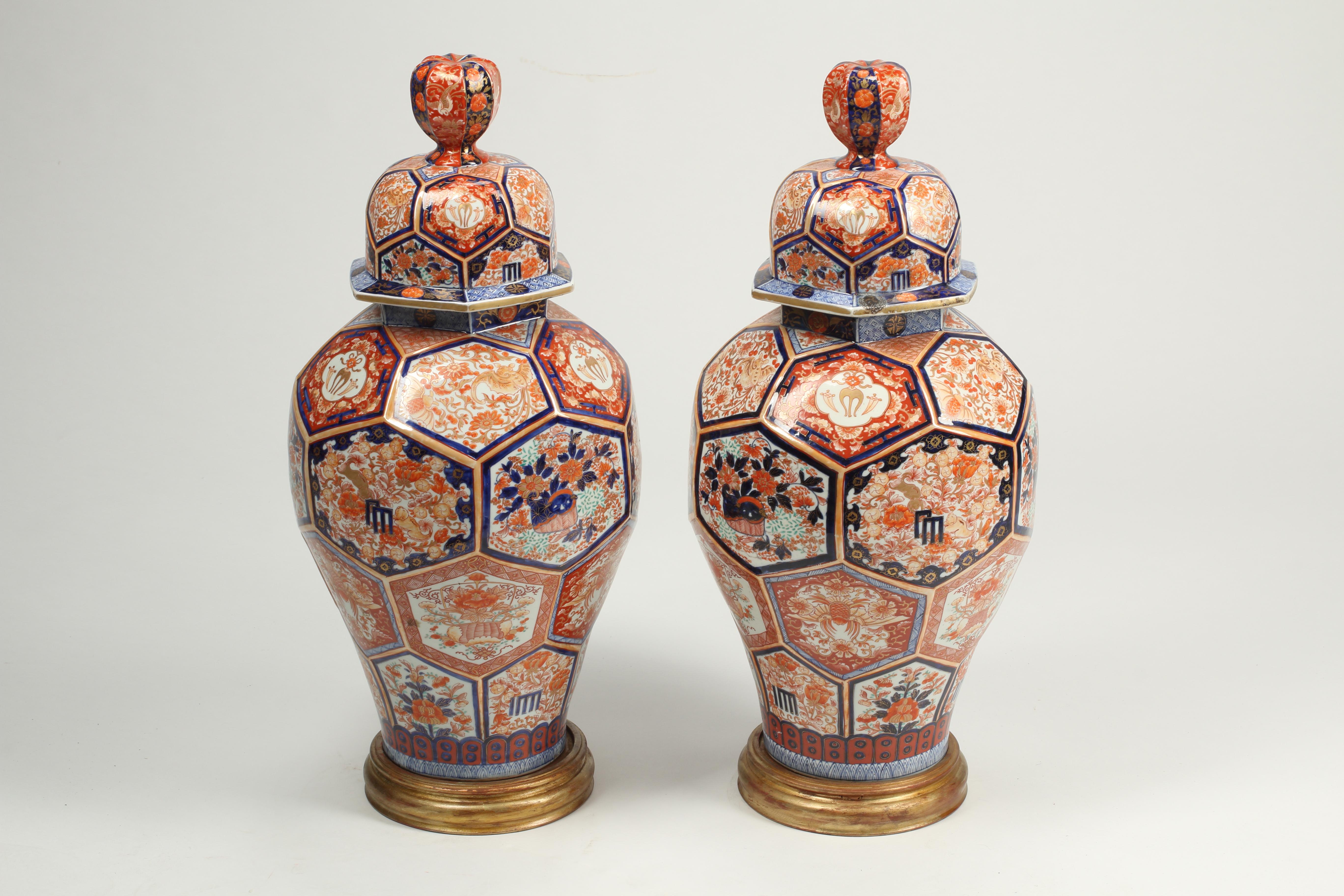 An exceptional pair of large scale late 19th century Japanese Imari temple jars from the Meiji period with covers, also can be referred to as ginger jars. Rare octagonal facet cuts and superb painting make these an exemplary decorative pair.
