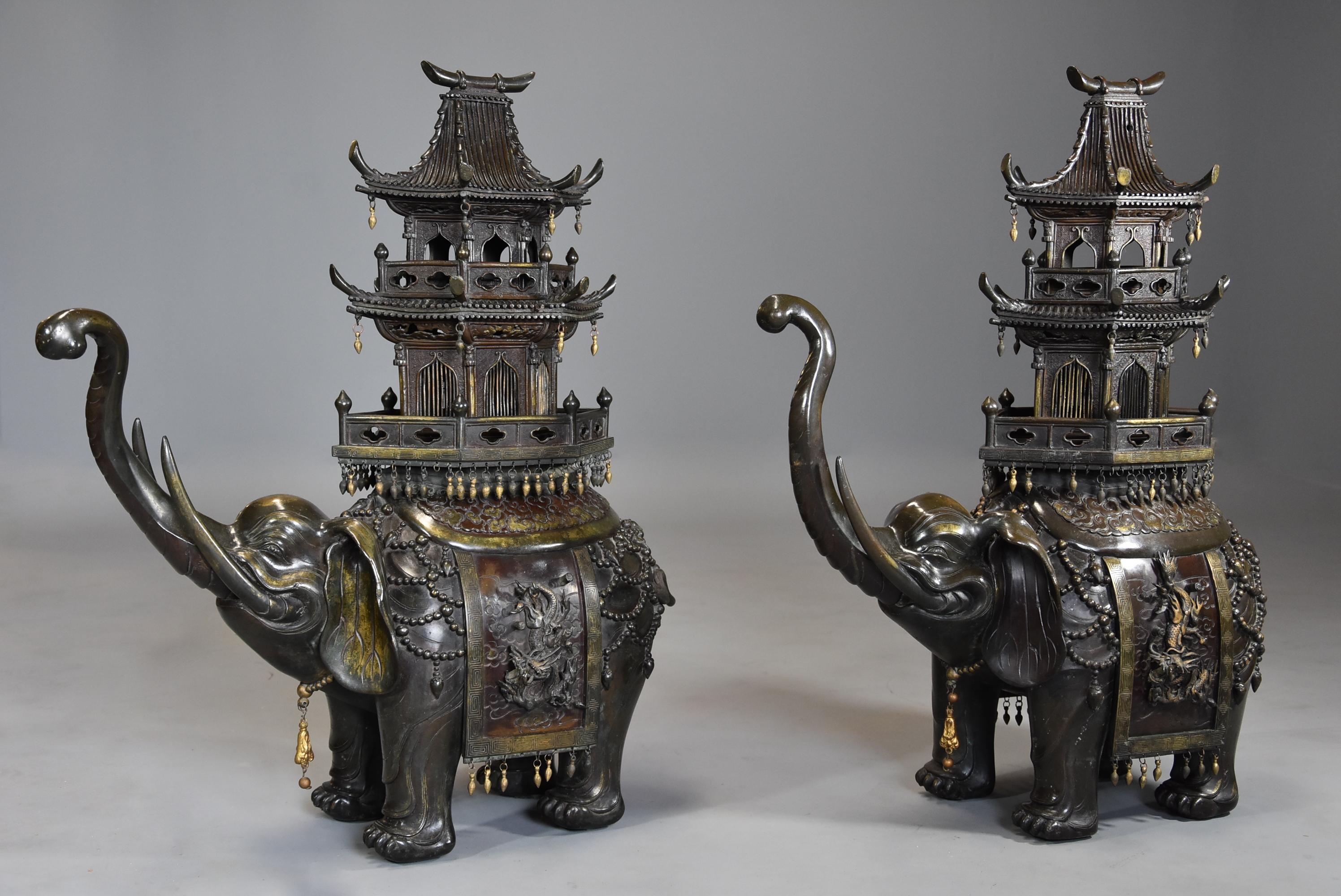 A large superbly fine pair of late 19th century Japanese Meiji bronze elephant incense burners or koro with pagoda temple covers.

This wonderful pair of incense burners consist of a pair of fine quality bronze and gilt bronze elephants with