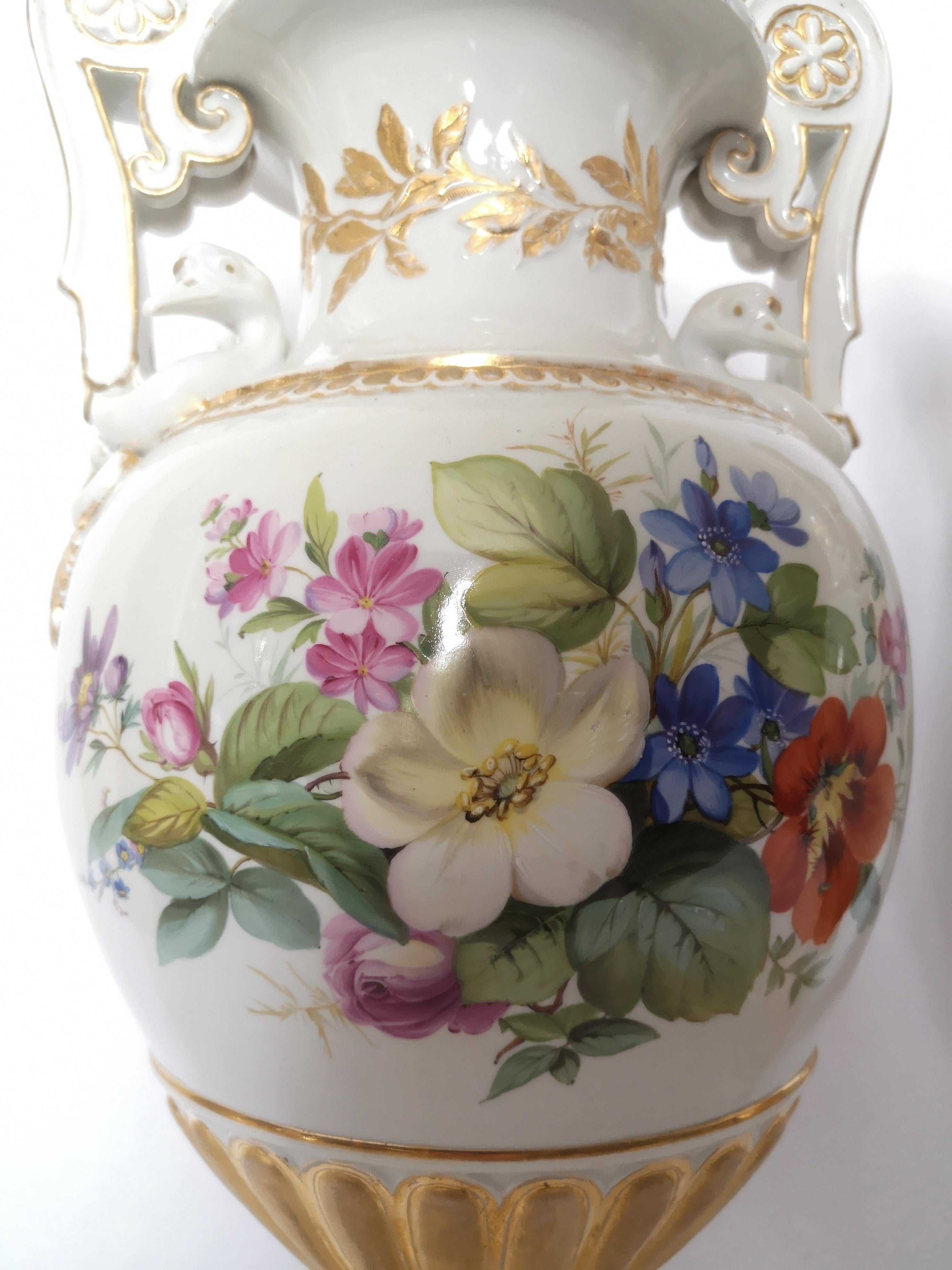 A good pair of large Meissen Porcelain vases. The main body with finely painted flowers front and back. The handles in the form of swans and pedestal type base with gilt highlights.

Meissen was the first European hard paste porcelain. The