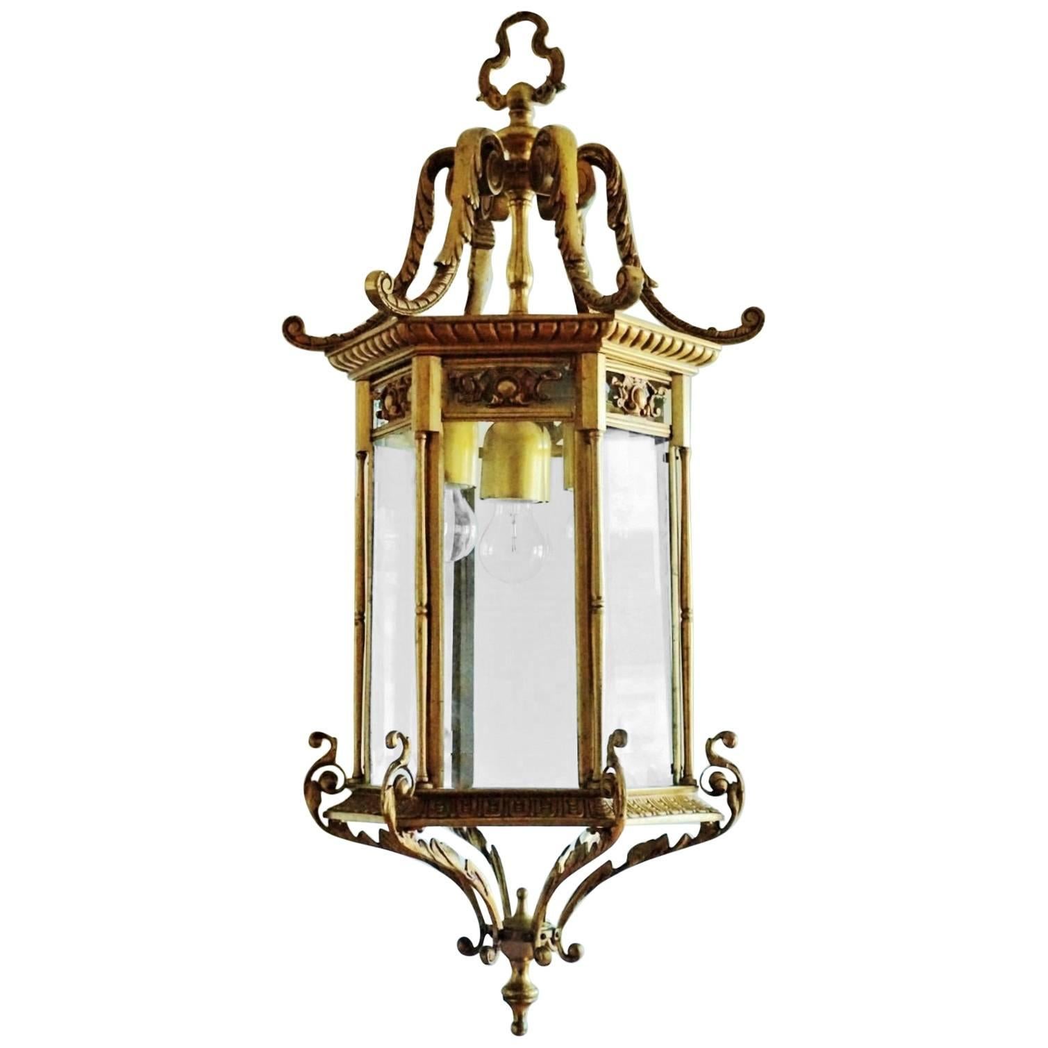 Pair of heavy, large Regency style thee-light lanterns, France, circa 1870-1880. The lanterns are of solid bronze and parcel brass with six faceted glass windows. The lanterns arrive with beautiful solid bronze canopy and chain.
Number of lights: