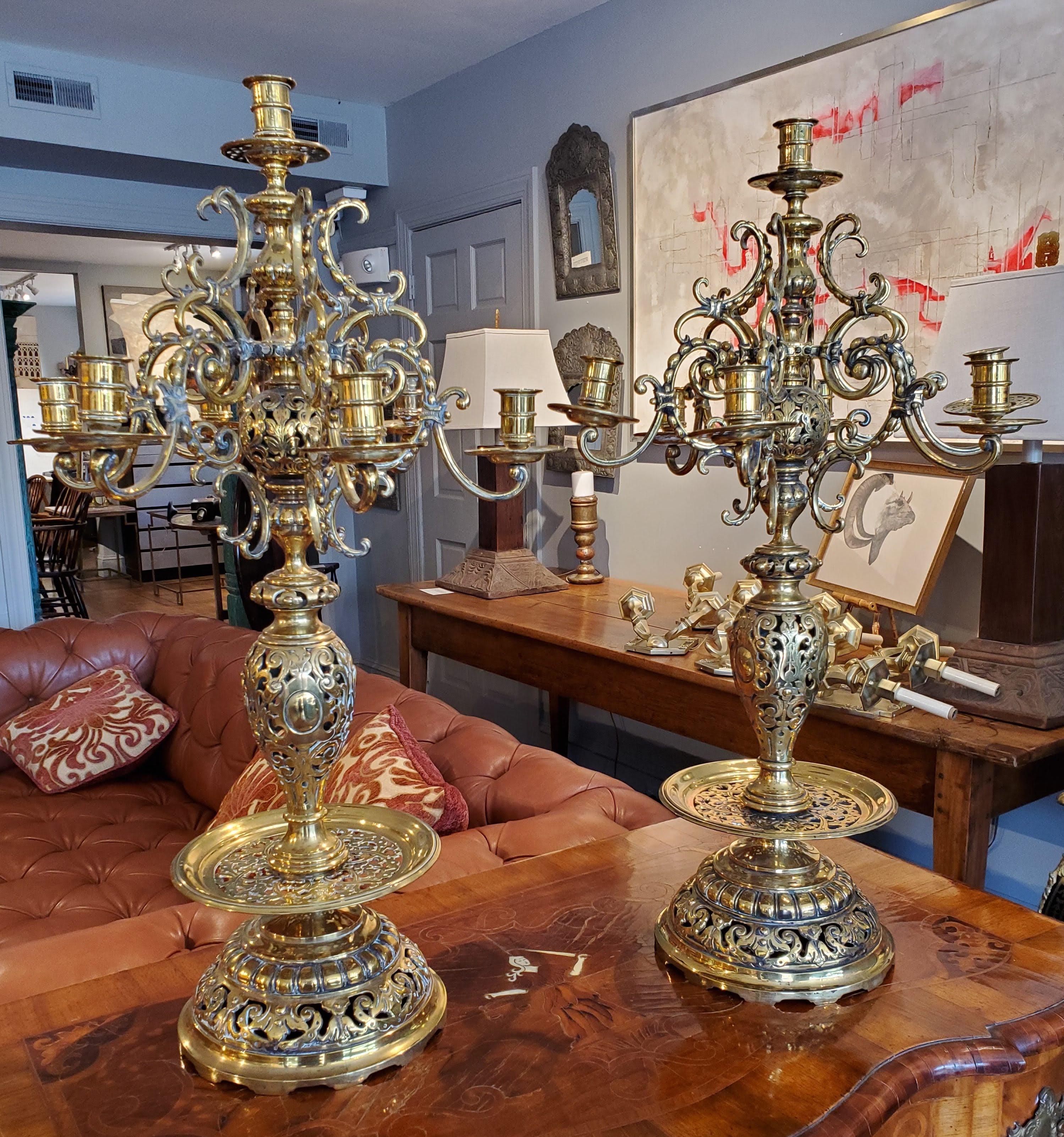 This large pair of 19th century Russian brass candelabra are impressive and command attention. Beautifully designed with Turkish influence, the vasiform with intricately scrolled and pierced decoration includes seven candleholders on each