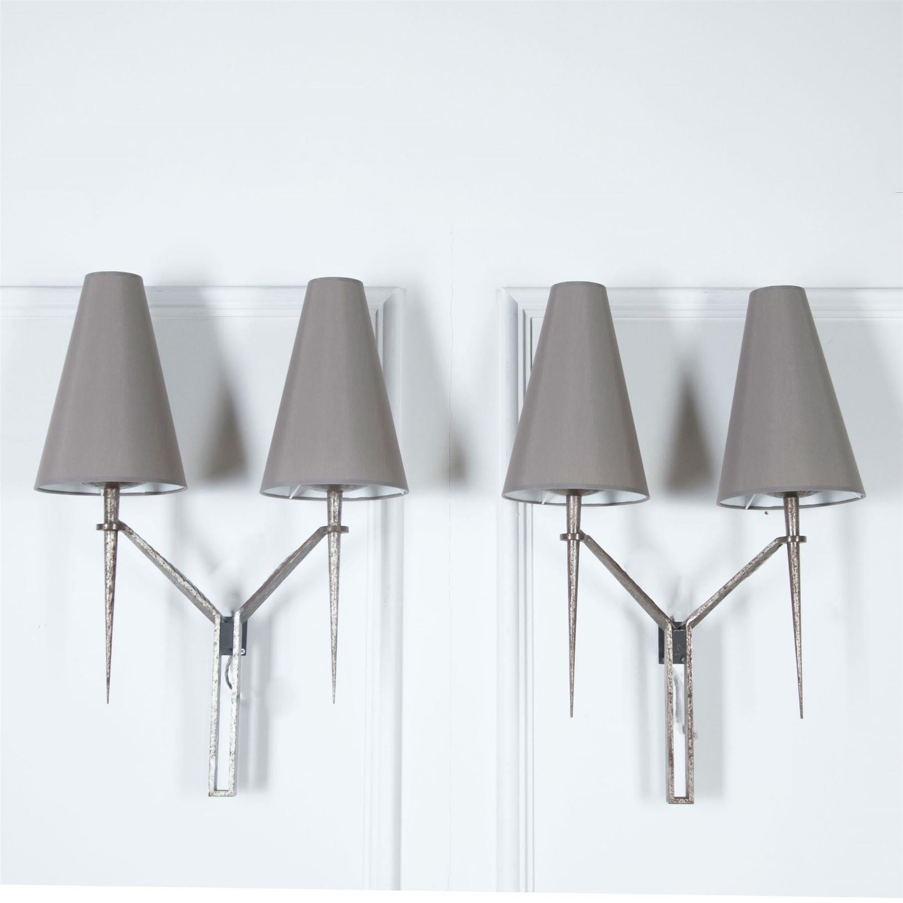 A good pair of large and imposing 20th Century double arm wall lights in polished iron. 

Fully rewired. Two pairs available, priced per pair.