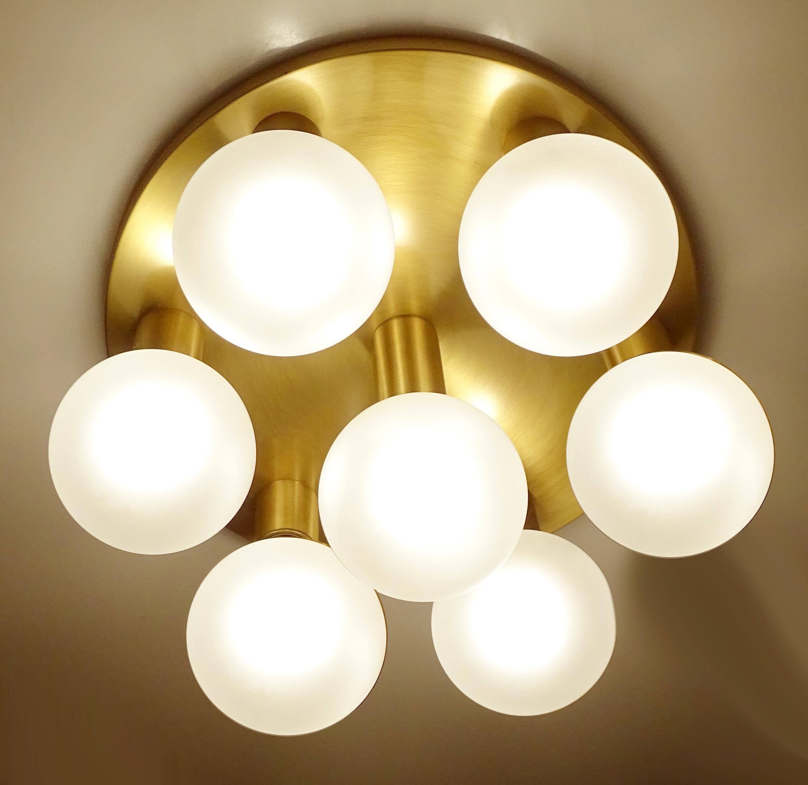 Pair of large midcentury flush mount Lights / sconces with seven lights , burnished brass base
Measures: 10.62 in. / 27 cm H (with bulbs)
Diameter
16.53 in. (42 cm).
Seven bulbs with max 60 watts each, best used with large globe bulbs as shown