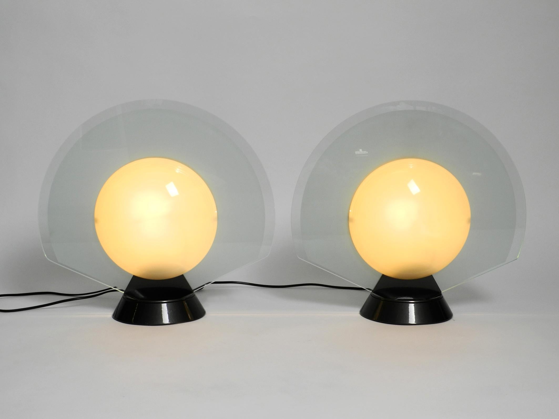 Pair of large 1980s table lamps by Pier Giuseppe Ramella model Tikal.
Made for Arteluce. Made in Italy.
Pier Giuseppe Ramella was a well-known Italian designer and architect.
Typical Postmodern Minimalist design.
Heavy aluminum base can be