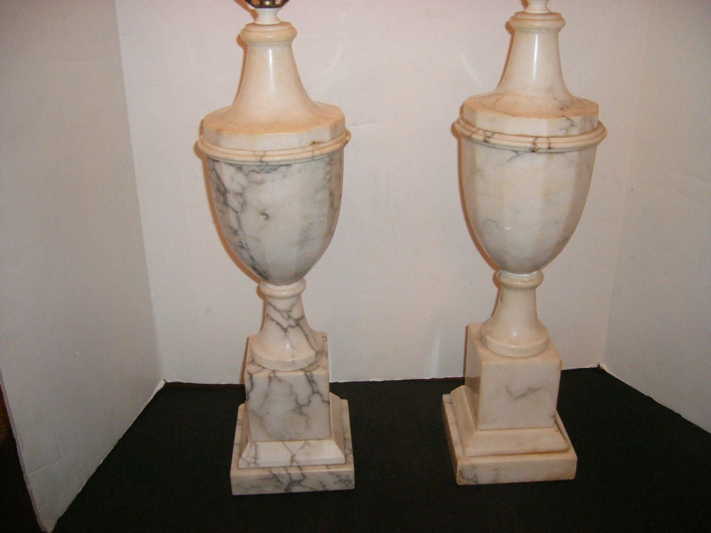 Pair of urn-shaped large alabaster lamps with gray veining on body. 

Measurements:
Height of body 21