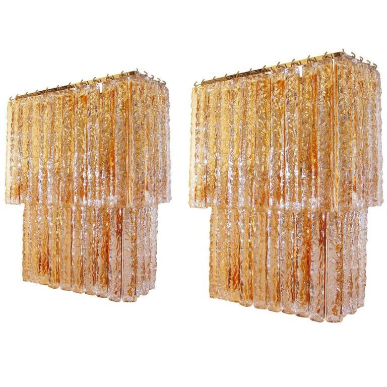 A pair of two-tiered amber and clear textured glass sconces attributed to Mazzega.

Italian, circa 1970s.