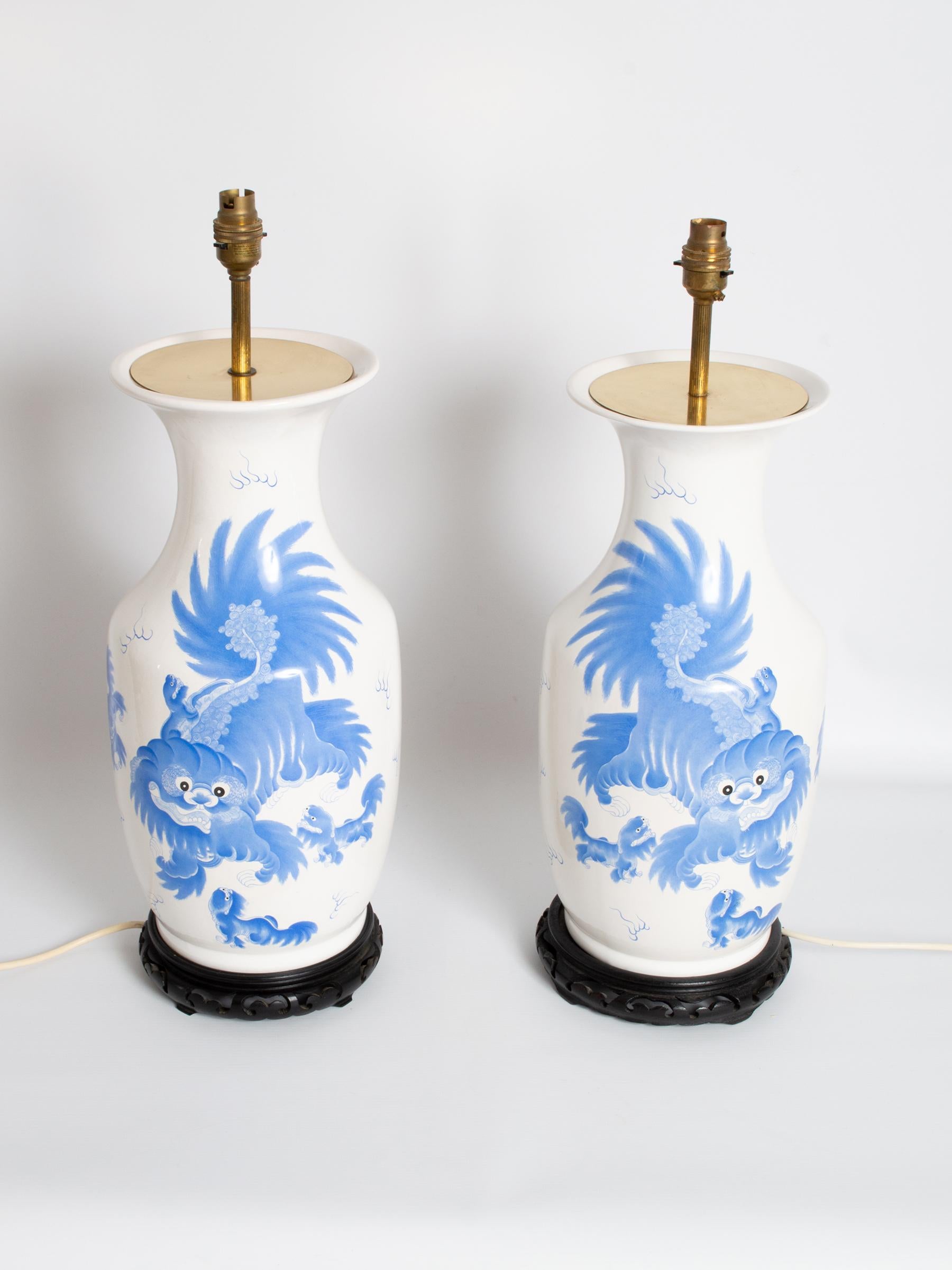 A fine pair of large antique 19th century blue and white dragon Chinese vase lamps.

In excellent condition commensurate of age. One lamp shows a very faint line of grazing to the porcelain (this can be seen in the photos).