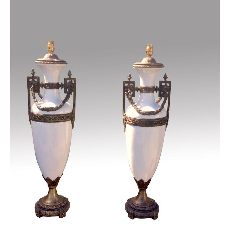 Magnificent pair of very tall antique bronze and white glass table lamps

84 cm to top of bulb holder tall x 22.5cm diameter
33ins to top of bulb holder tall x 9ins diameter

Declaration: This item is antique. The date of manufacture has been