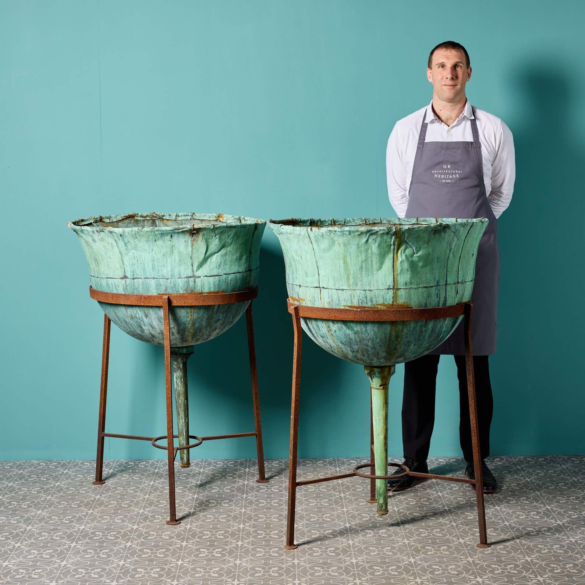 A huge pair of large scale, tall antique copper planters dating from the late 19th century. Once used as roof finials and repurposed, these striking reclaimed planters are unique sculptural features for a garden, their large scale certain not to be