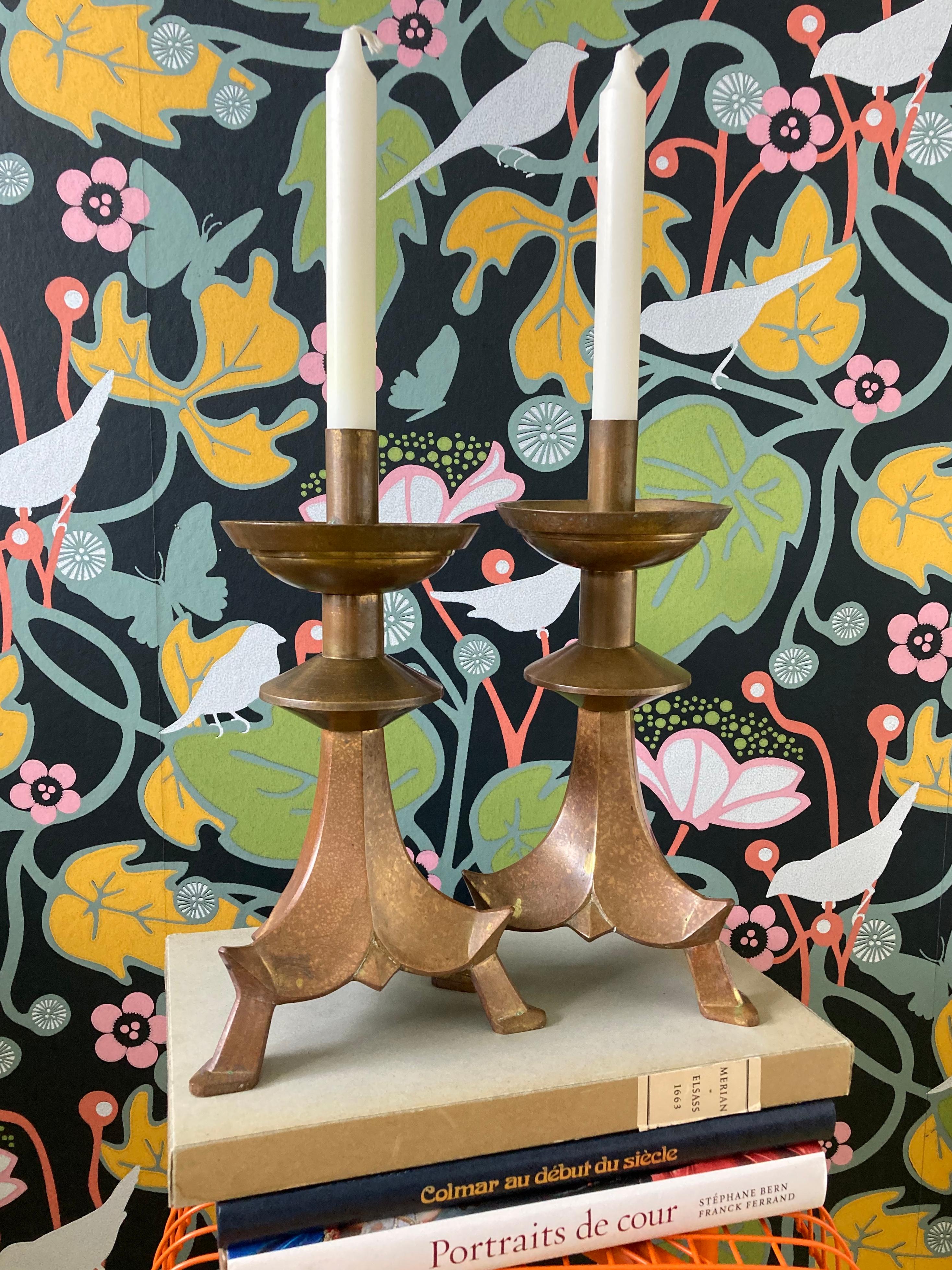 A pair of large, antique, tripod candlesticks in brass in a unique chinoiserie style. Their néo-gothic, pagoda shape and their impressive size (12 inches tall) make them highly decorative. 

These candlestick could possibly have been made for