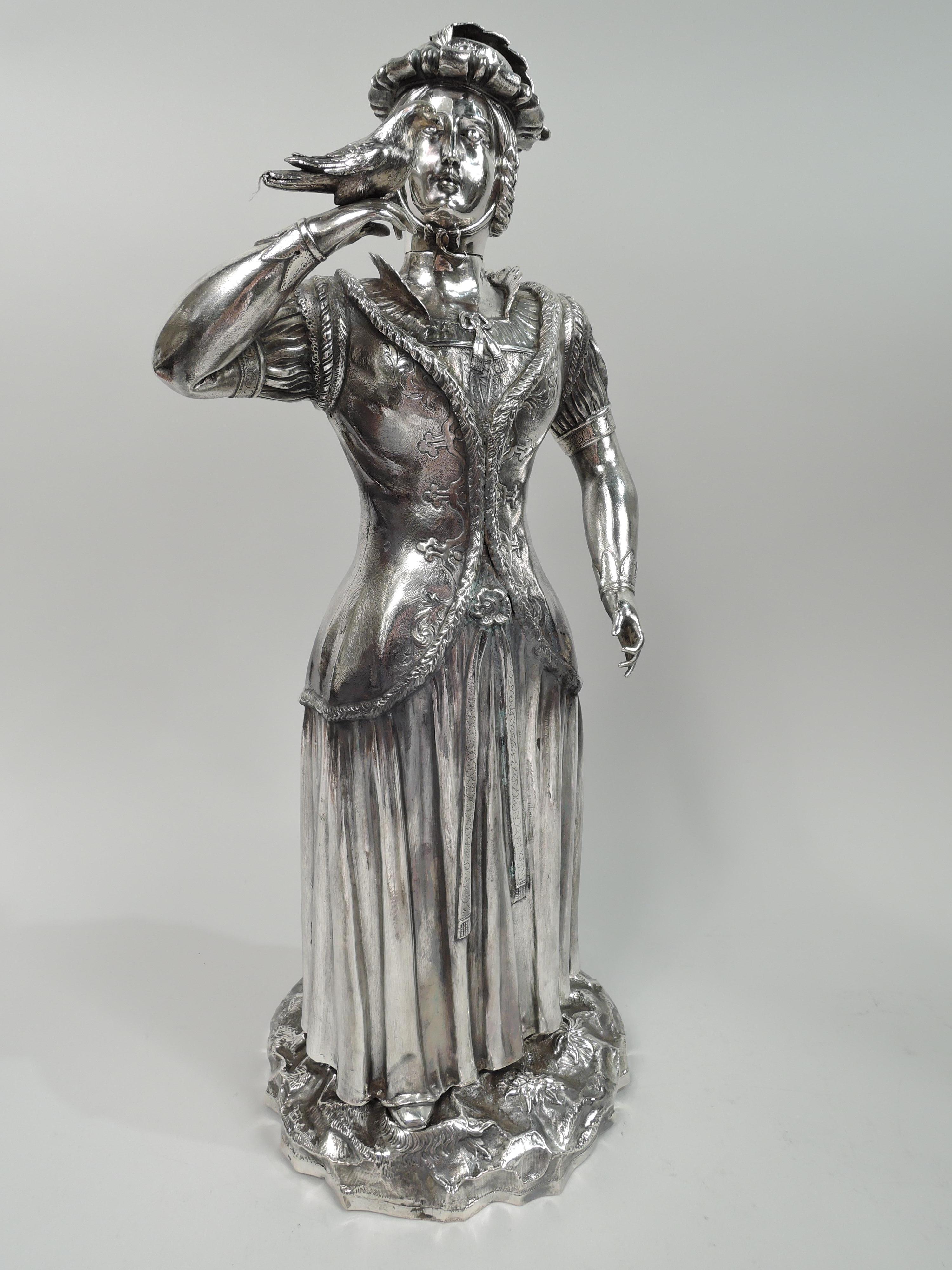 Pair of German silver Renaissance hunting figures, ca 1890. The man wears doublet over baggy chemise and hose with belt hanging loosely around hips. A long hat feather drapes gracefully along his arm. The horn is raised expectantly while the other