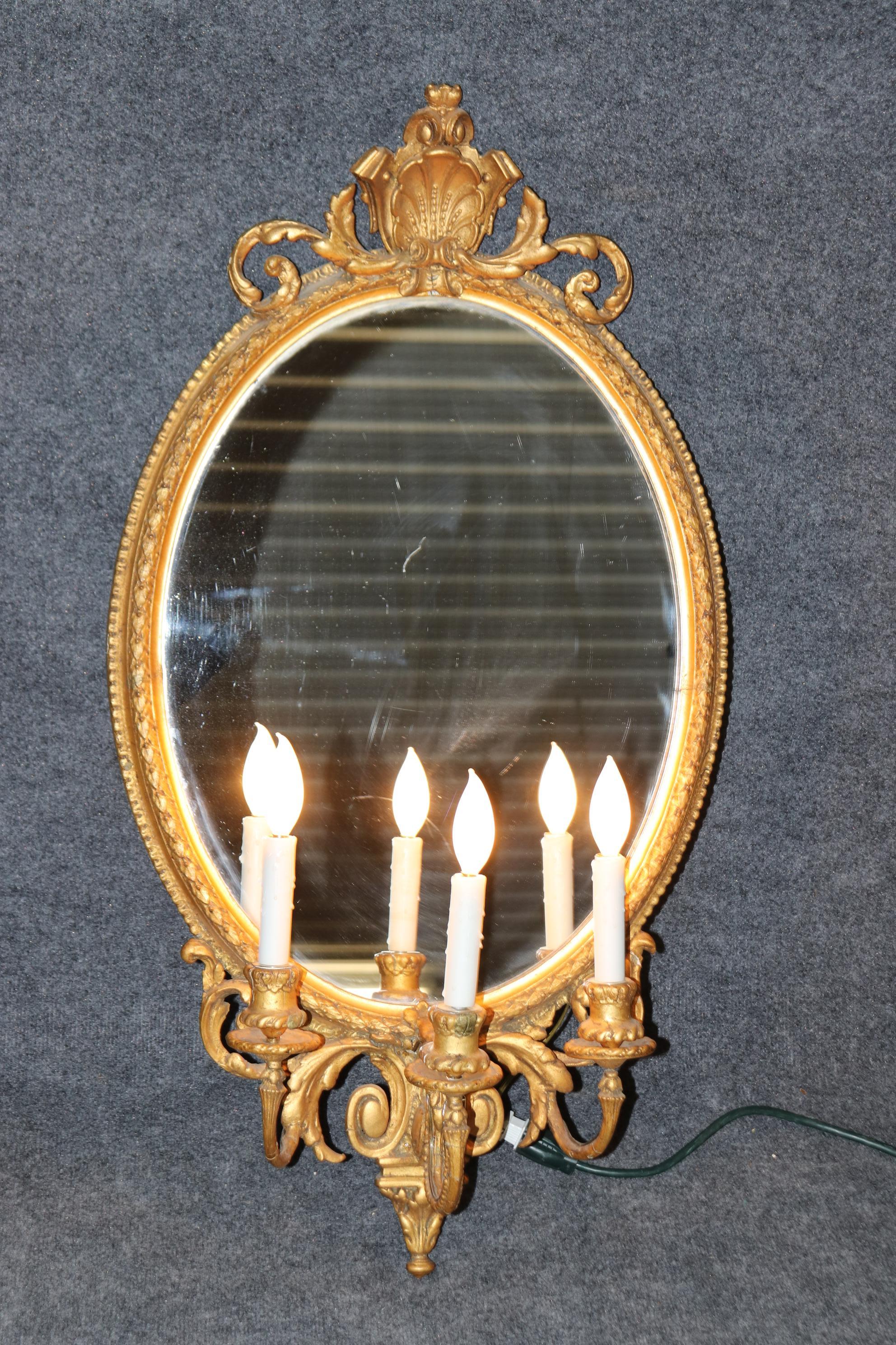 This is a beautiful pair of antique English mirrors in the Georgian style with carved shells and gorgeous gilded frames. They are antique and will have minor age related cracks here or there but that is entirely normal. They are wired and should