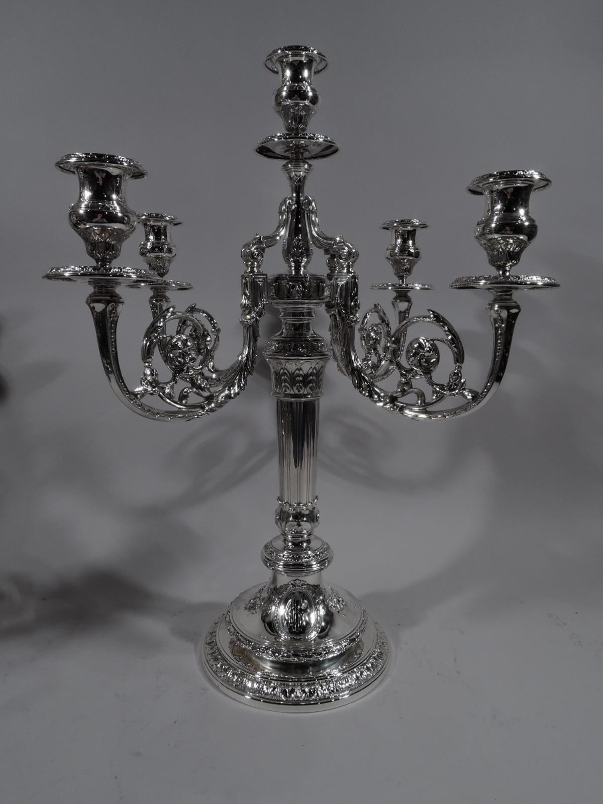 Pair of large French neoclassical sterling silver five-light candelabra. Made by Gorham in Providence, circa 1910.

Each: Tapering fluted shaft with vertical leaves at top and bottom. Double-domed base with reeded, leaf-and-dart, and