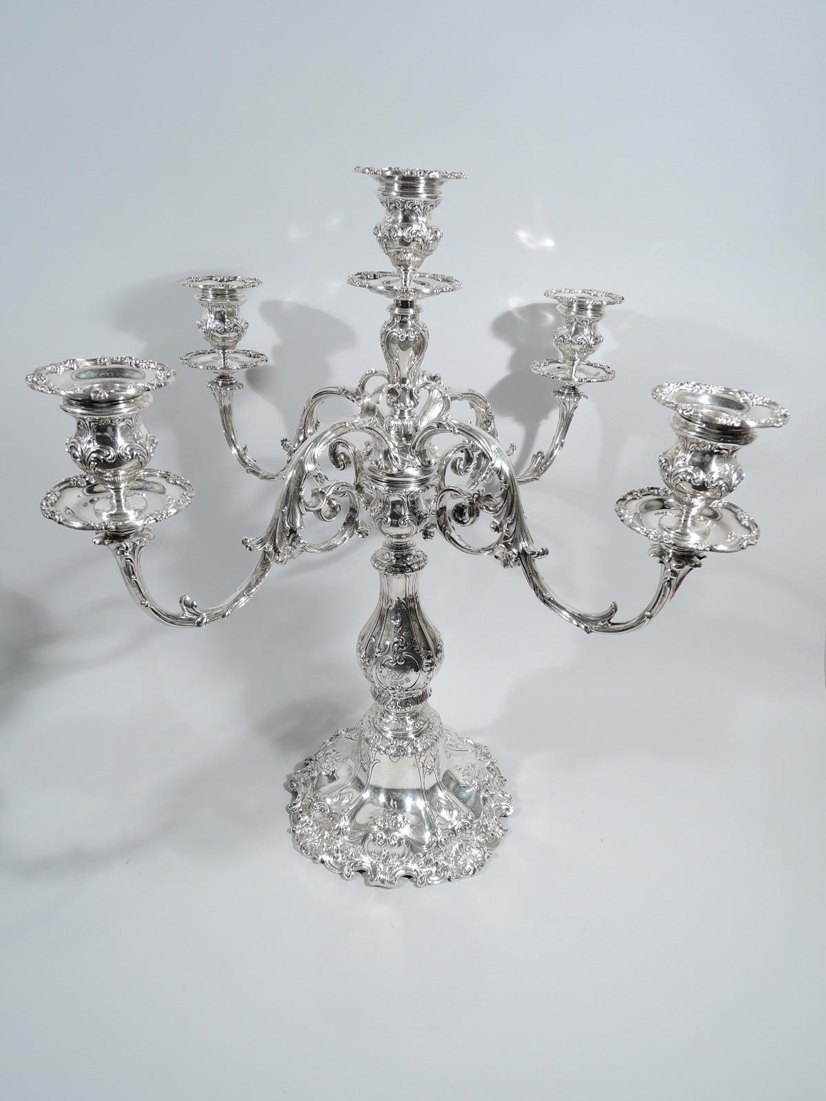 Pair of Edwardian sterling silver 5-light candelabra. Made by Gorham in Providence in 1908. Each: Sturdy baluster shaft on domed foot. Urn supporting central baluster terminating in socket, surrounded by 4 leaf-capped and mounted scrolled branches,