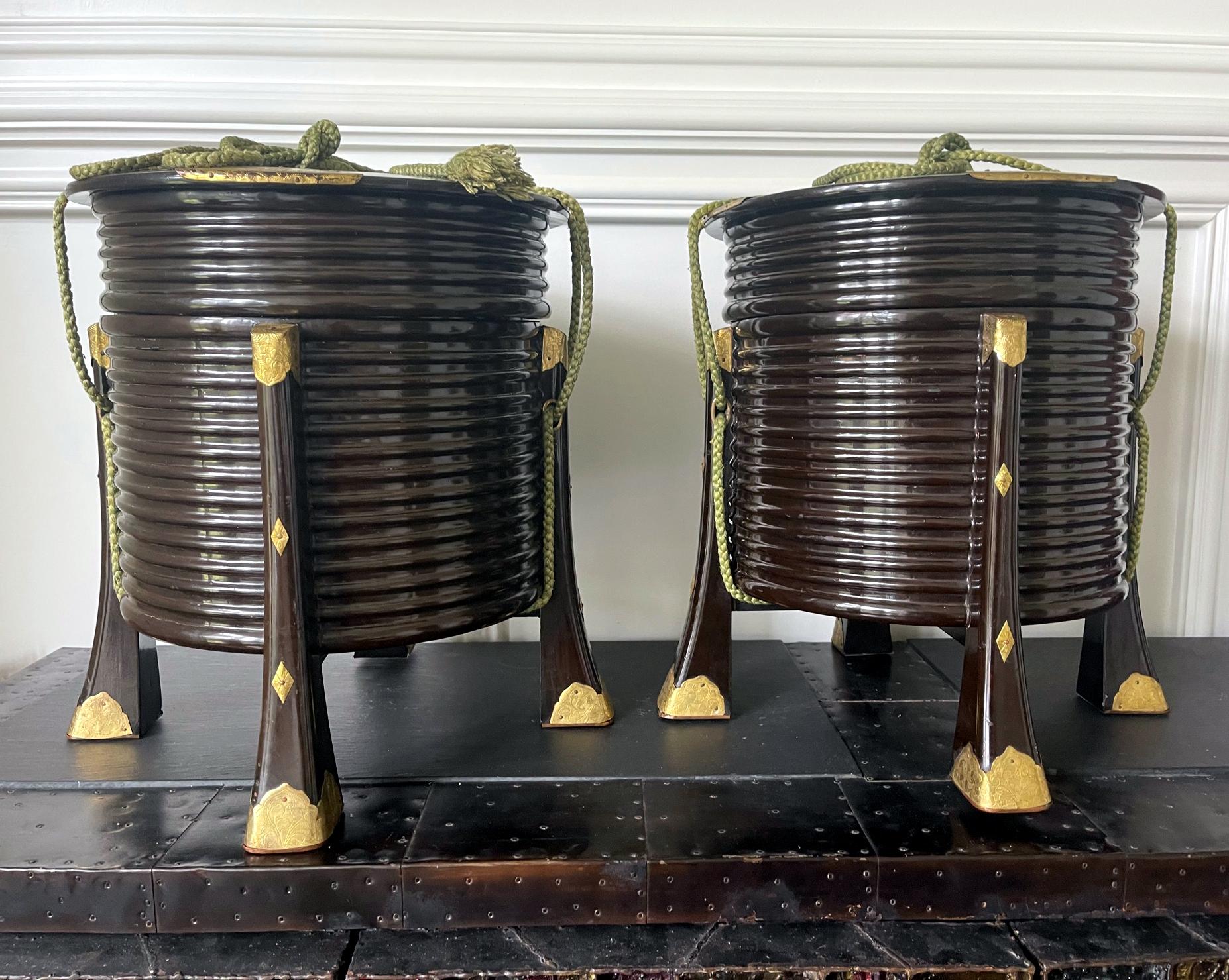 A pair of Japanese lacquer lidded Hokai boxes with chased brass hardware and original ropes. Hokai boxes are traditionally used in Japan to store and carry shells for Kai-awase game in Edo and Meiji Period. Always in pair for the nature of the game,