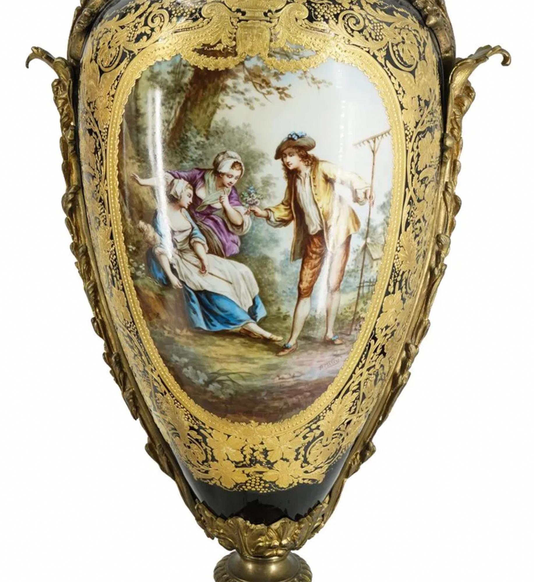 important Pair of Sevres porcelain urns, each featuring a porcelain body and foot mounted on a gilt bronze base and adorned with gilt bronze, foliage form trimmings and handles. Each piece bears an image on either side of its body depicting a scene