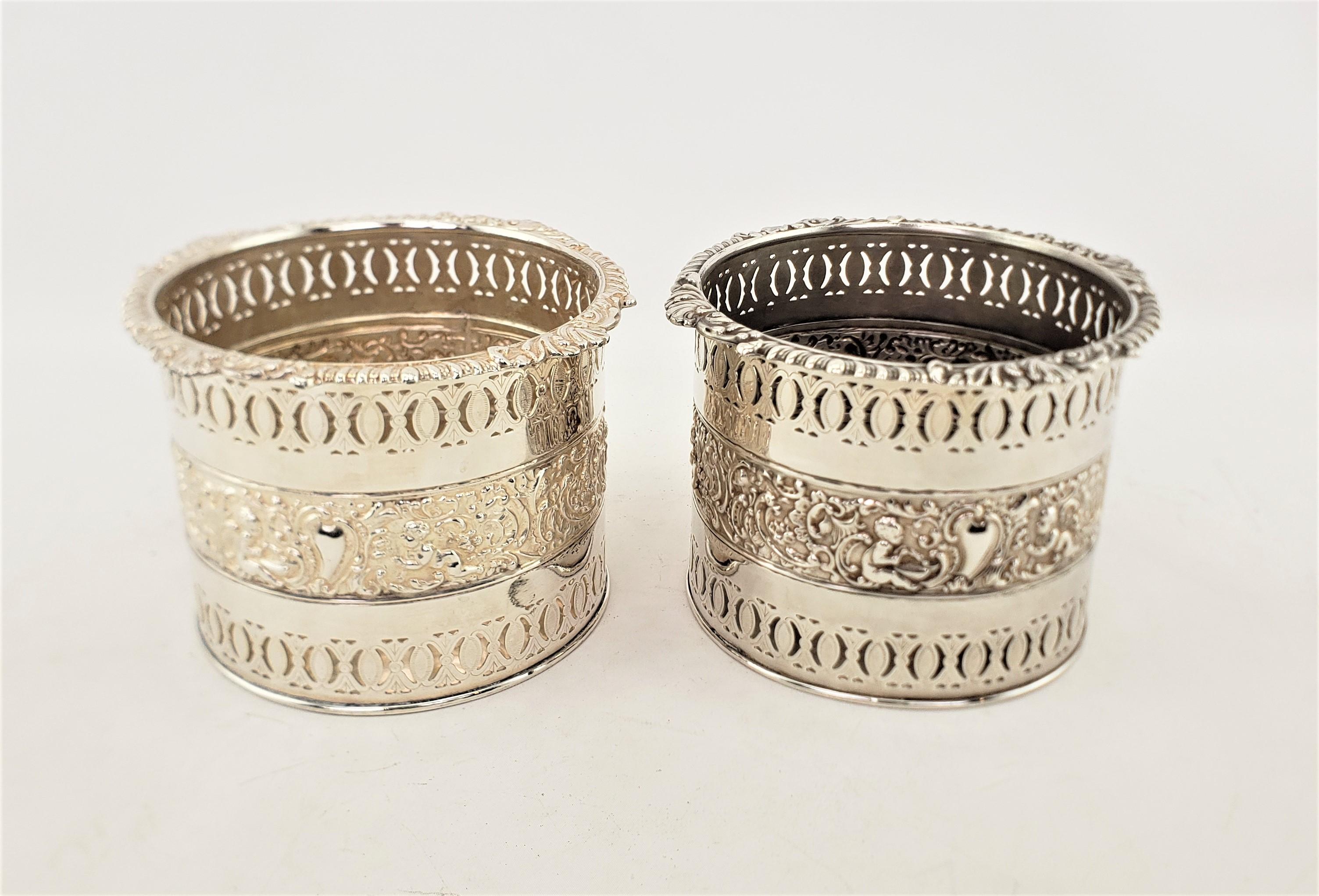 Late Victorian Pair of Large Antique Silver Plated Bottle Coasters with Repousse Decoration For Sale