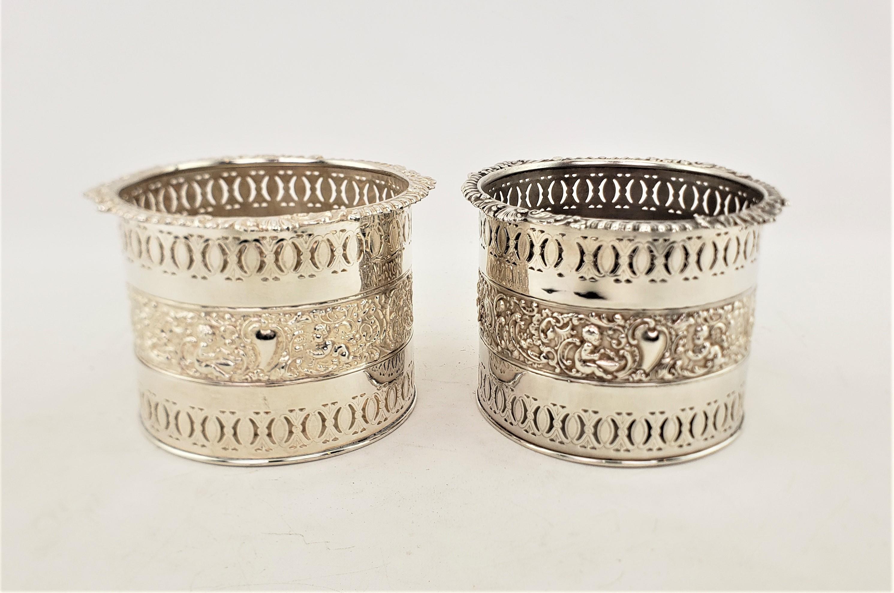 English Pair of Large Antique Silver Plated Bottle Coasters with Repousse Decoration For Sale