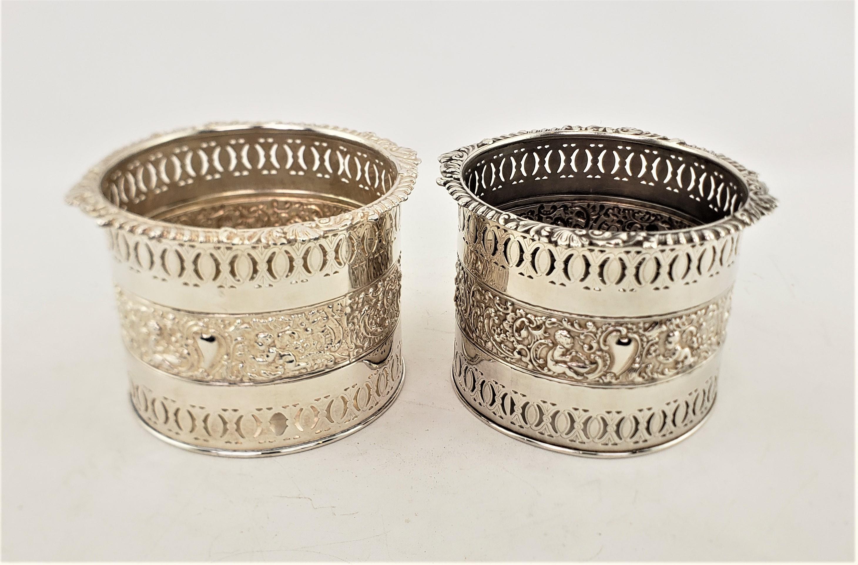 Machine-Made Pair of Large Antique Silver Plated Bottle Coasters with Repousse Decoration For Sale