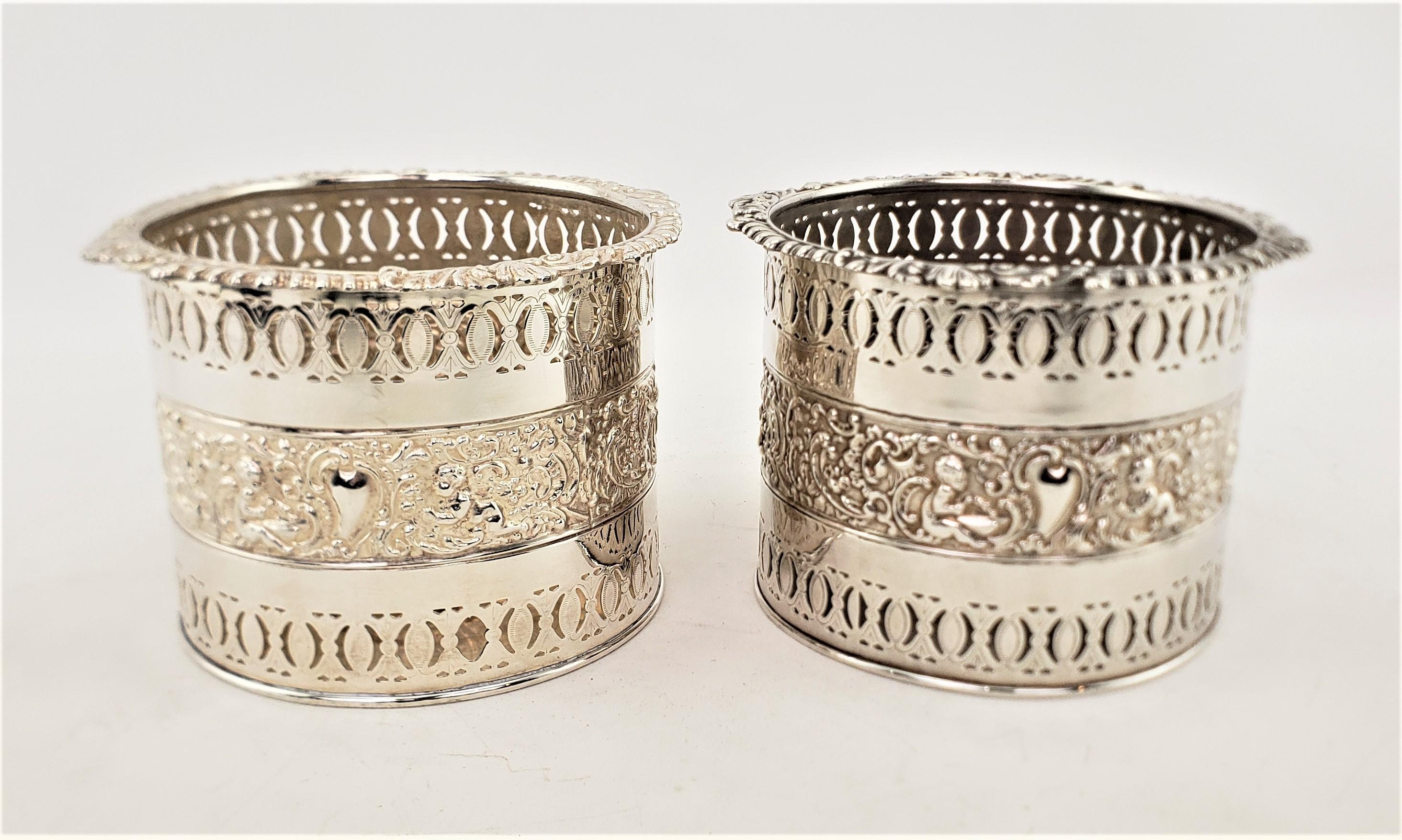 Pair of Large Antique Silver Plated Bottle Coasters with Repousse Decoration In Good Condition For Sale In Hamilton, Ontario