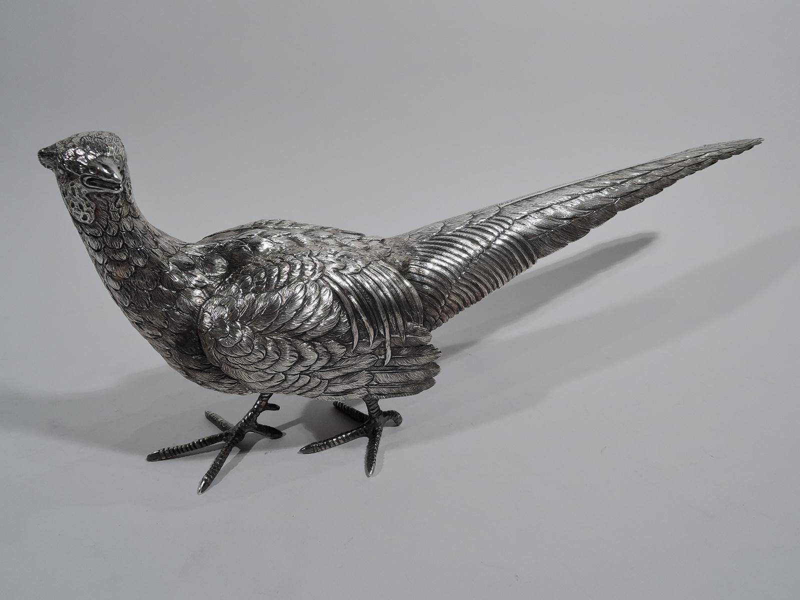 Pair of large sterling silver pheasants, circa 1920. Two birds on the alert. One crouches low with raised wings. The other looks to the side. Fierce and wary with big scaly talons and dense, textual plumage. Versatile, too. Can be posed to suggest a
