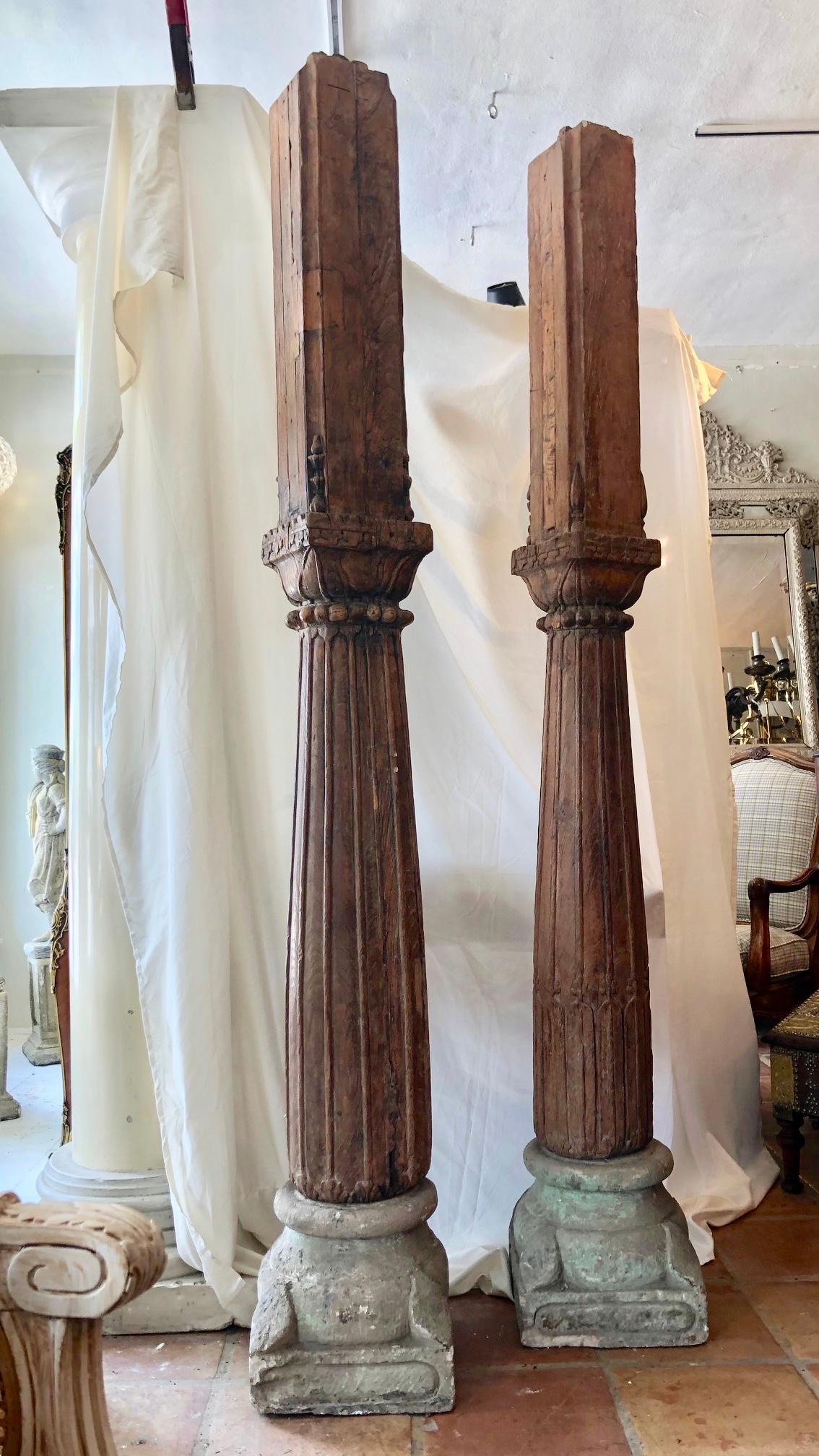 These are an unusual pair of antique wood with stone base pillars or columns.
The scale is large, important, and heavy
They are solid oak with some fine carvings.
There is a cut out to one side with a lip to the top. Indicating
that they were