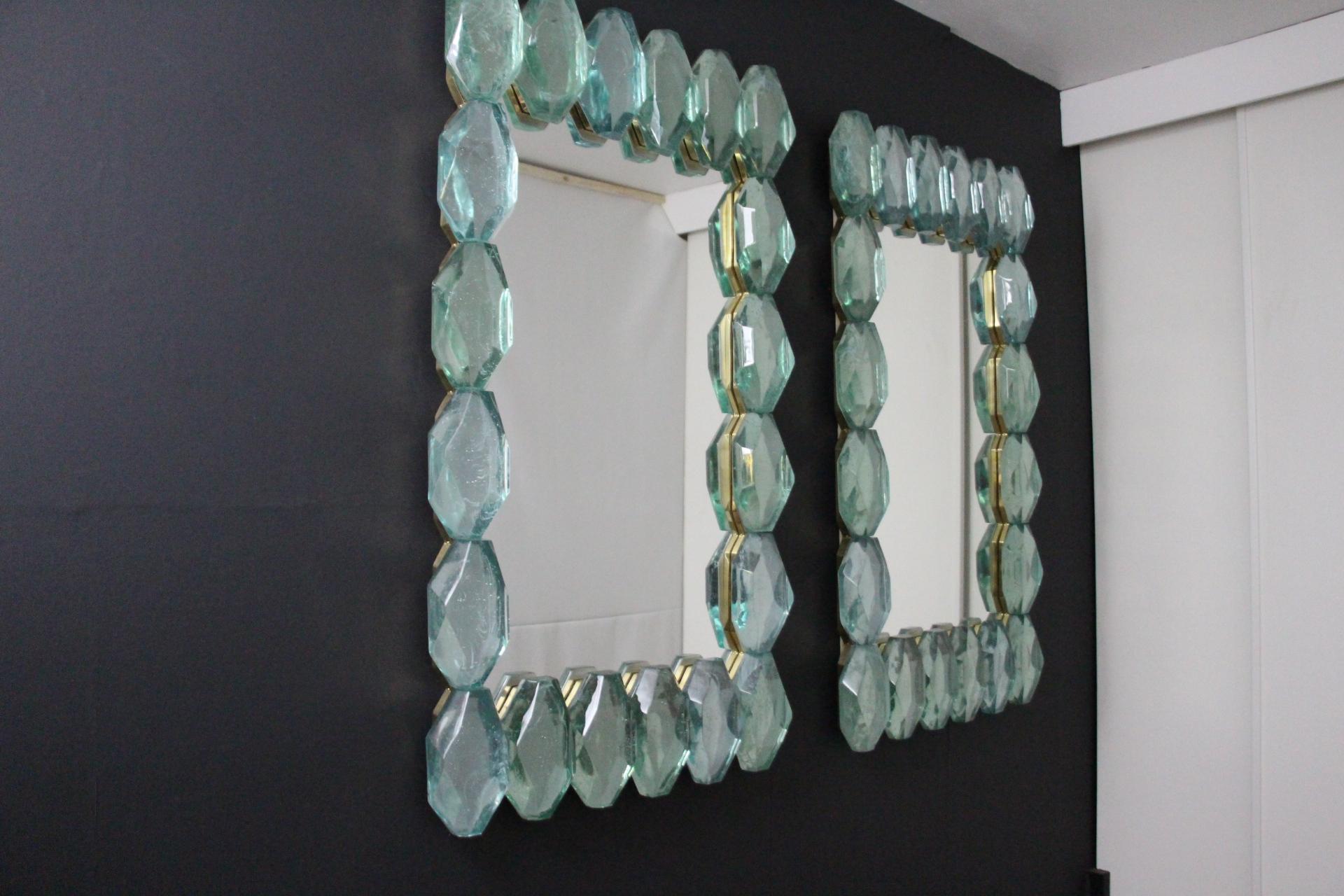 These blue -green Murano glass mirrors are absolutely fabulous. First, its solid blocks of glass in faceted diamond shape are very unique and bring a very luxurious and unusual feeling. Then , the color of glass is really spectacular , it looks like