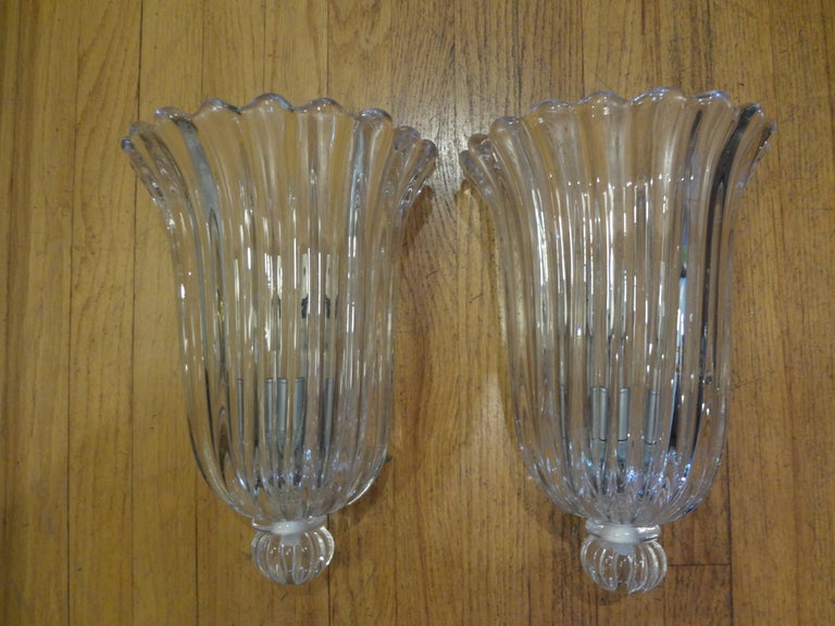 Stunning pair of large Archimede Seguso signed and labeled clear murano glass sconces. These beautiful substantial murano glass sconces have a great ribbed design terminating in a sphere. This pair of signed and labeled Archimede Seguso (1909-1999)