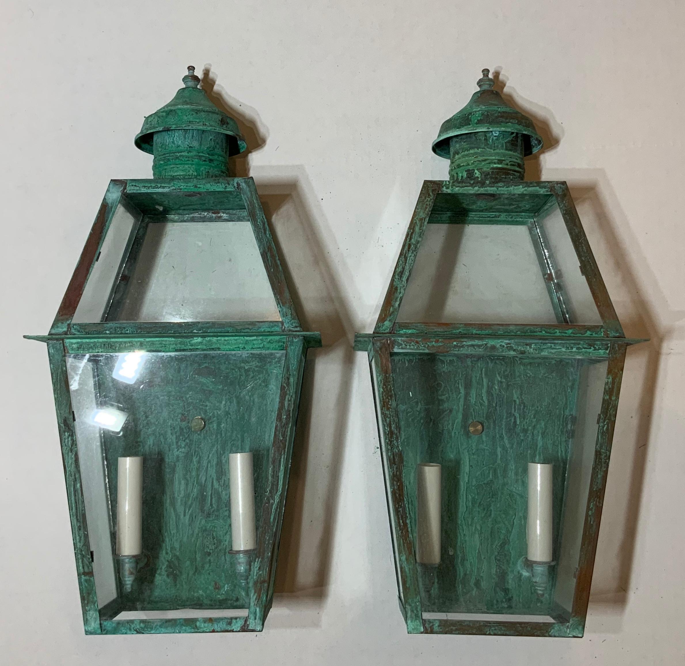 Elegant pair of wall lanterns made of copper beautifully weathered, with two
60/watt lights each electrified and ready to light.
Up to US code UL approved, suitable for wet locations, made in the USA.