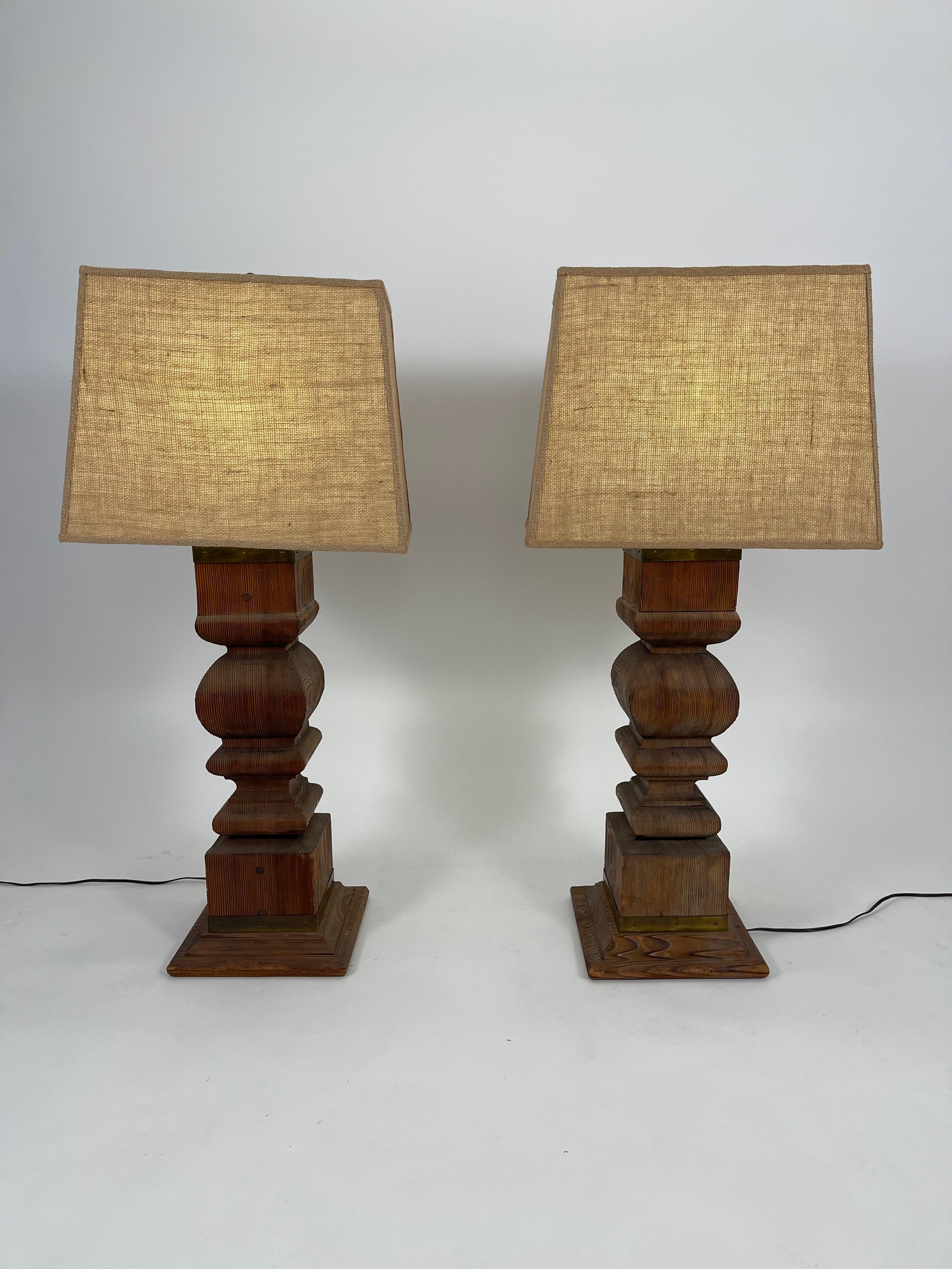 A pair of large, architectural lamps made from Japanese cypress balustrades mounted with brass fittings, together with high quality custom made burlap covered shades. With beautiful figure and texture to the wood, this pair of striking lamps has