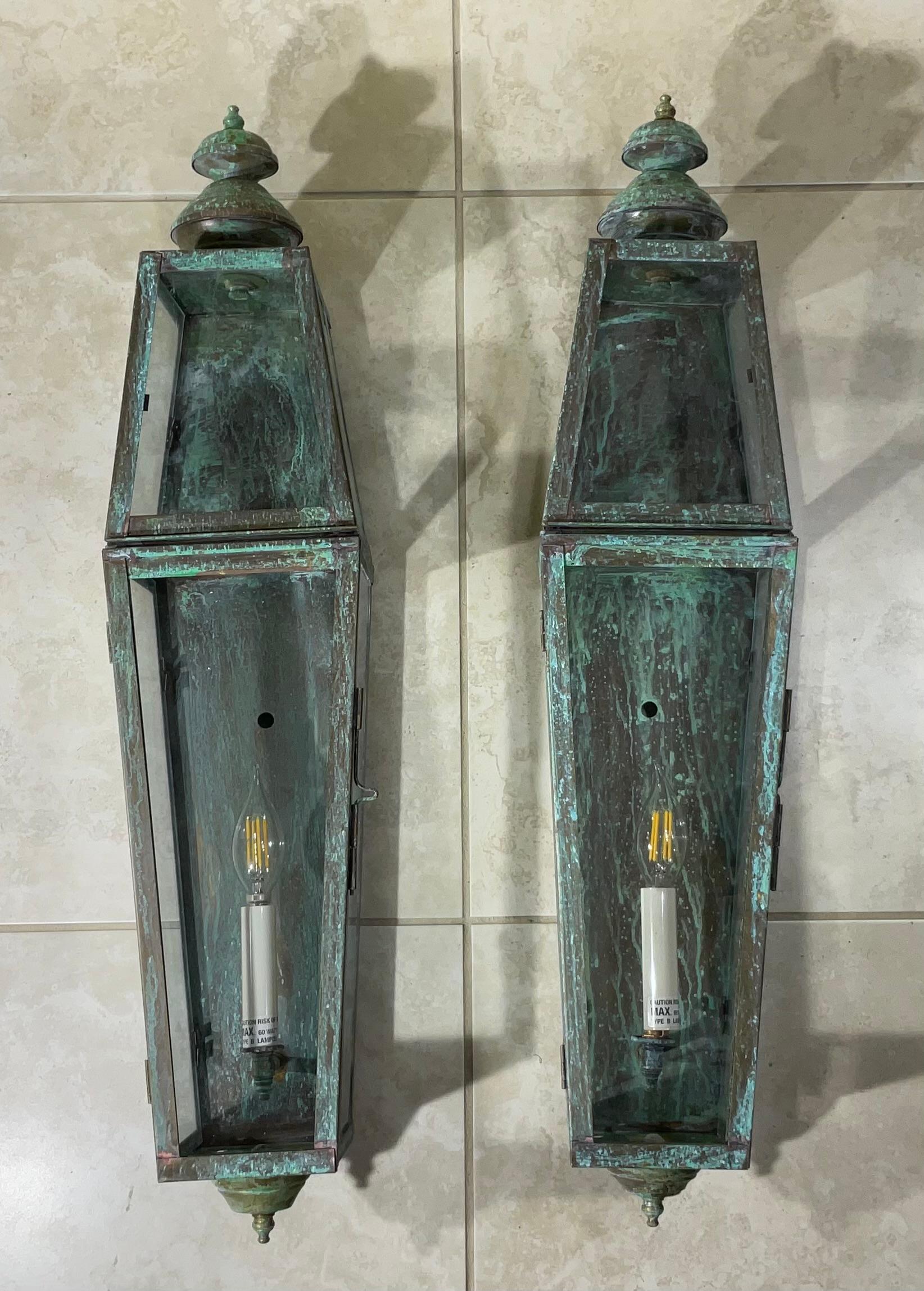 Pair of wall lantern or wall sconces, made of solid brass ,beautiful patina , decorative top and bottom finials ,one 60/watt lights each lantern,
Suitable for wet locations, UL approve. Up to US code .
Great looking wall lanterns for any entrance.
