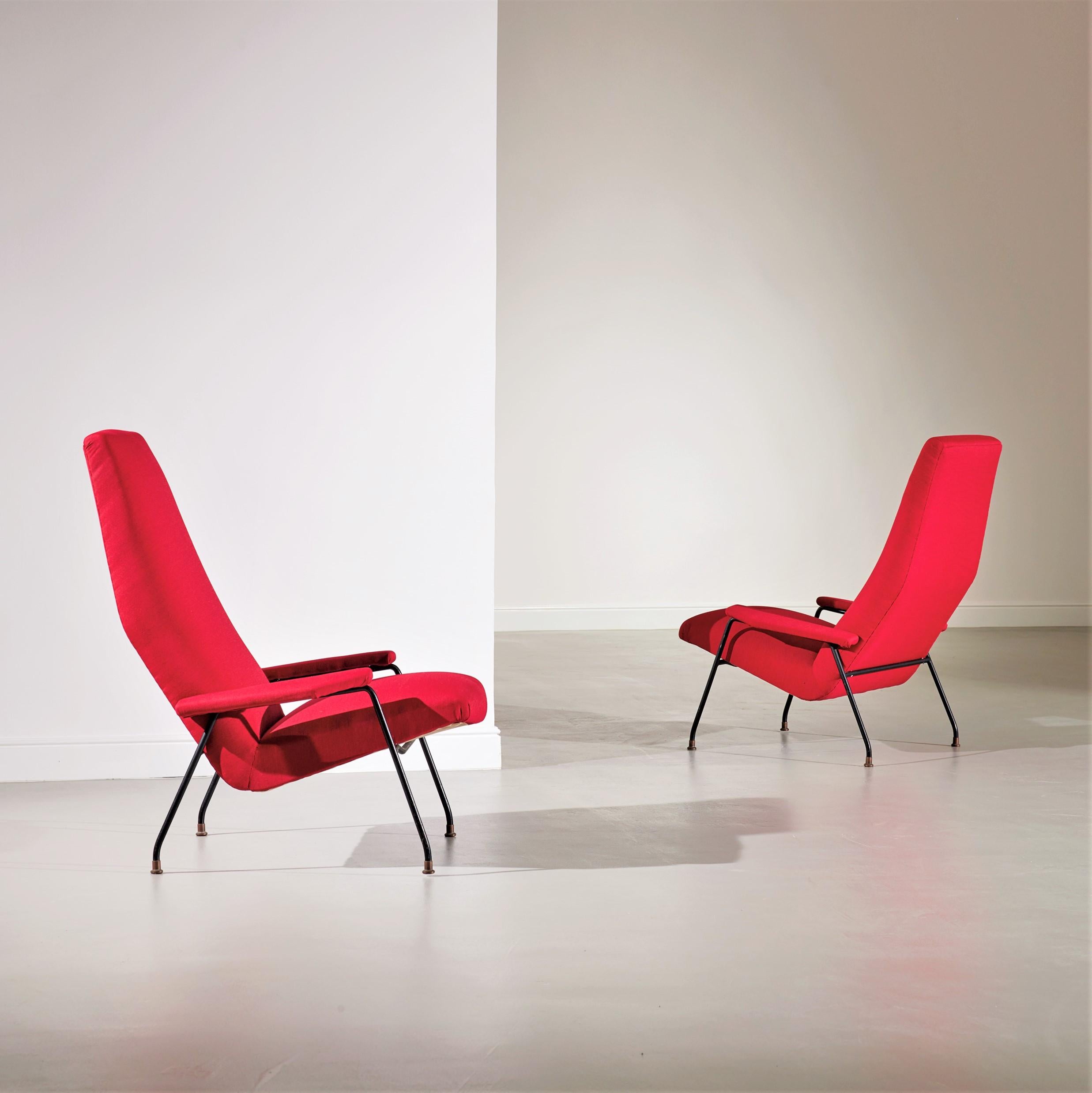 This large and impressive pair of lounge chairs was produced by Saporiti Italia in the 1950s from a design attributed to Augusto Bozzi. The chairs have been upholstered in a red textured fabric and feature Bozzi's renowned black-painted steel frame