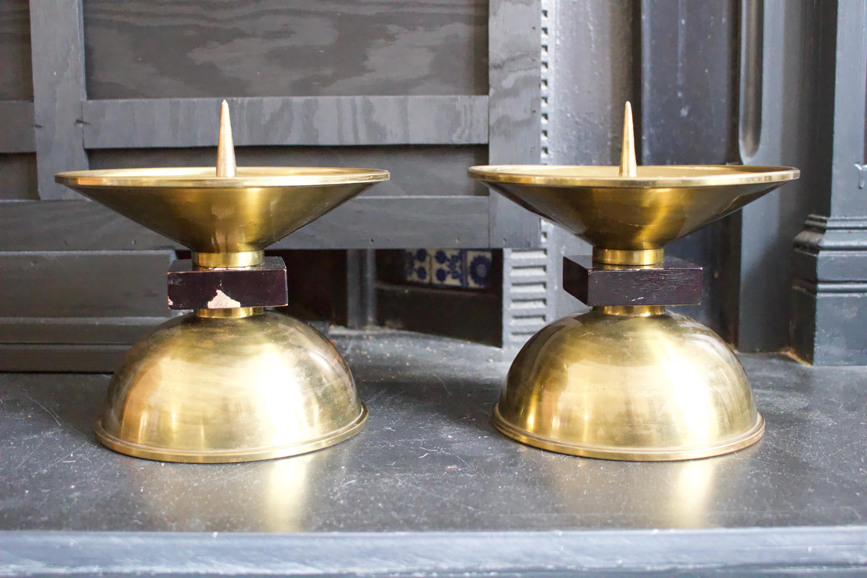 A pair of large candleholders with wood detail on the stem, early to Mid-20th Century. European, found in Germany, designer unknown. 

These pieces are nicely made of spun brass and wood, each with a separate brass dish which rests in the top and