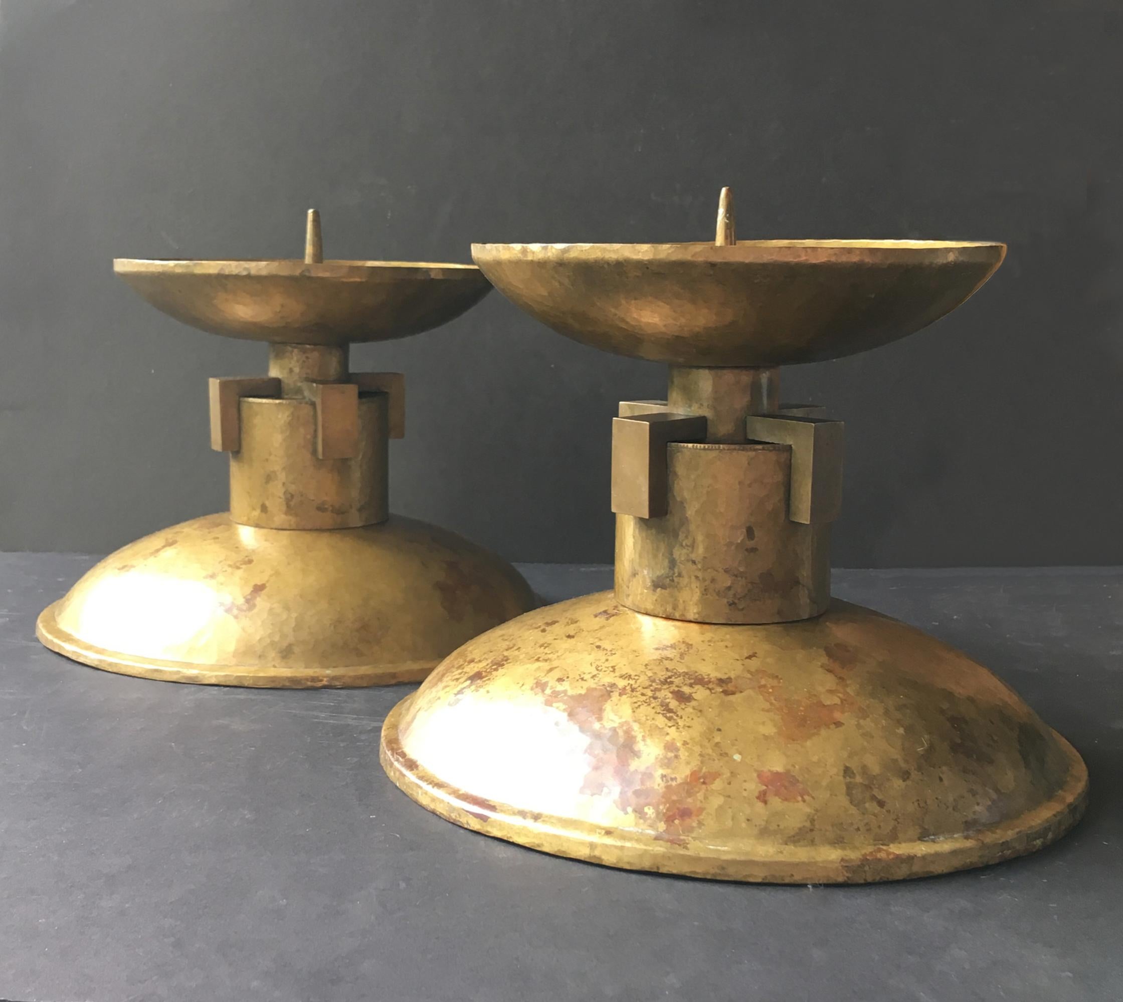 Pair of very large Art Deco candleholders with square milled brass details on the stem, early to mid-20th century, European.

The main body of each piece is made of hammered brass, or possibly gilt bronze, giving a mellow tone to the finish, which