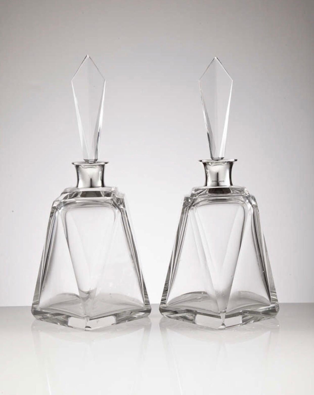 A pair of large Art Deco glass and English silver decanters fully dated London, 1920 by makers Hukin & Heath.
The geometric form and elegant tall stoppers give them an overall stunning look.

We are always adding to our 1stdibs catalogue so be sure