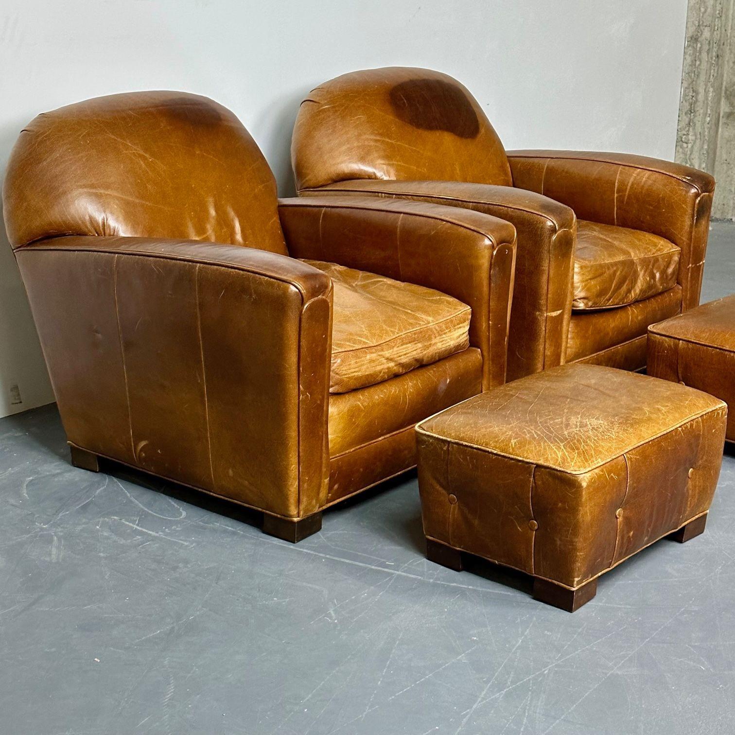Pair of large Art Deco distressed leather French club / lounge chairs.
 
A fine example of art deco lounge / club chair design accompanied by a rare pair of footstools, sold separately. Large and impressive, these iconic pieces bear the character