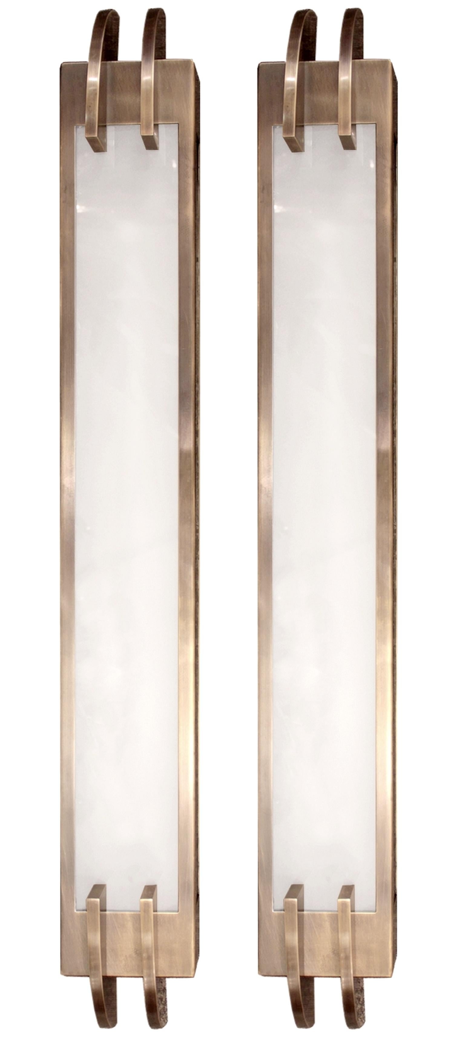 Two large Art Deco sconces in patinated brass and sandblasted glass.
The lighting consists of a fluorescent tube hidden inside the wall lamp.
Quality manufacturing.

Measures: Total height 37.4 in
Height of the central part 31.5 in
Width 4.7