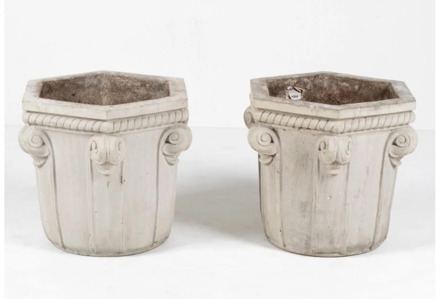 Pair of large Art Deco style cast stone outdoor planters with hexagonal openings. 