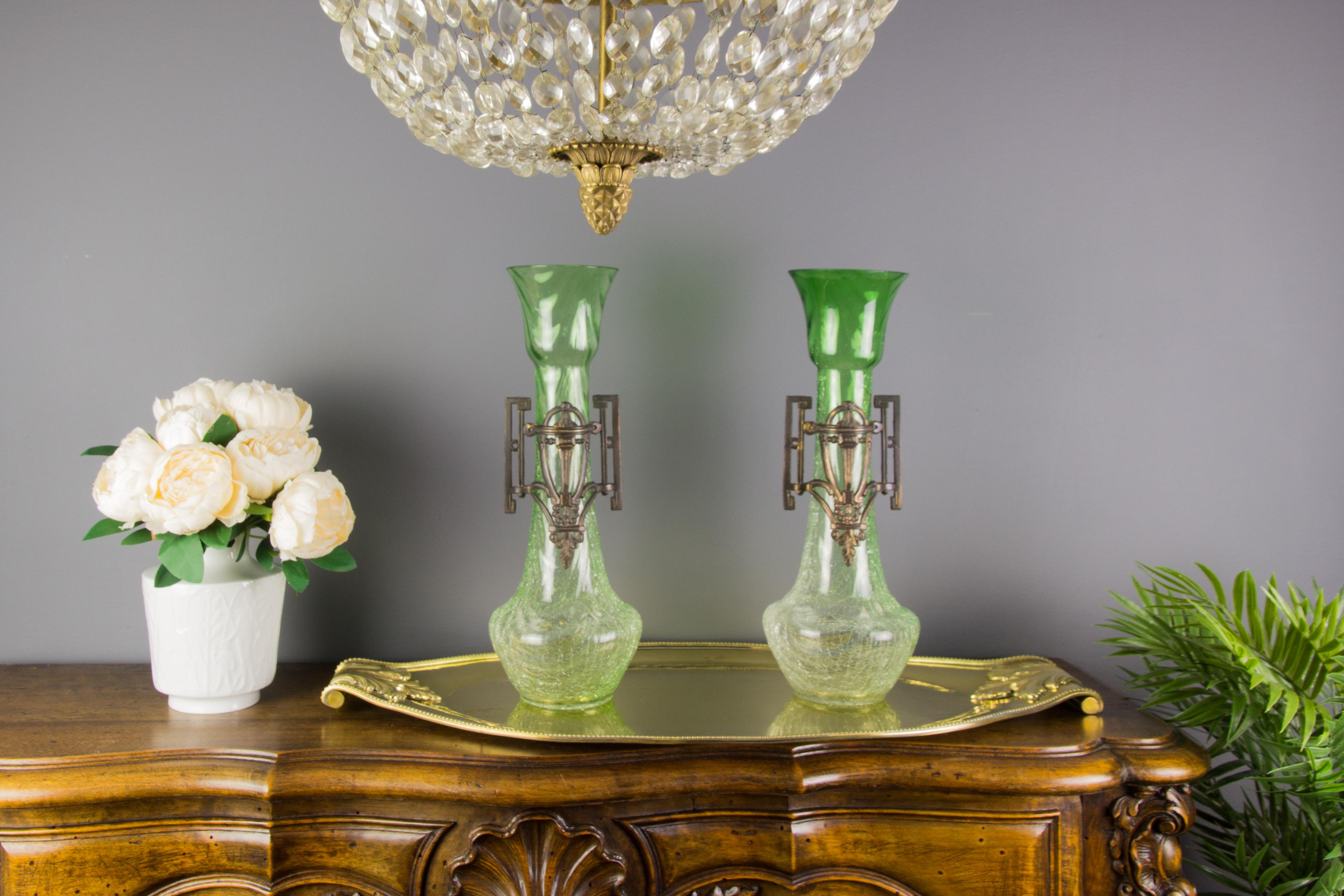 A beautiful pair of large Art Nouveau vases made of clear green crackle glass with stylized Art Nouveau patinated pewter ornate mounts.
Dimensions: height 40 cm / 15.74 in, diameter 14 cm / 5.51 in.