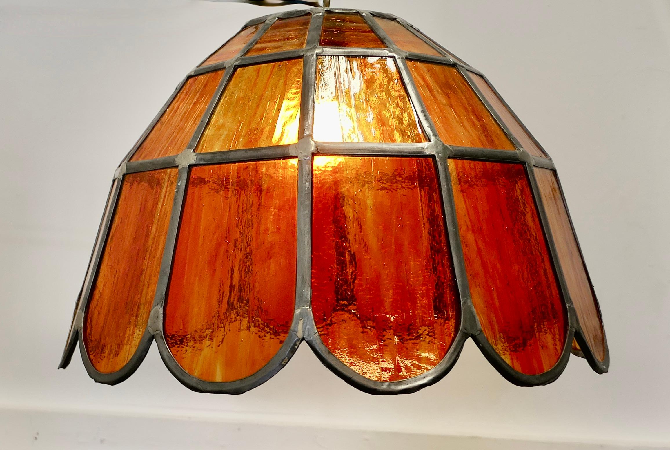  Pair of Large Arts and Crafts Amber Leaded Glass Pendant Lights

These are a super pair of ceiling lights, they are made with petal shaped panes of Amber Leaded Glass 
These are a very heavy pair and in excellent condition, they are 18” in diameter