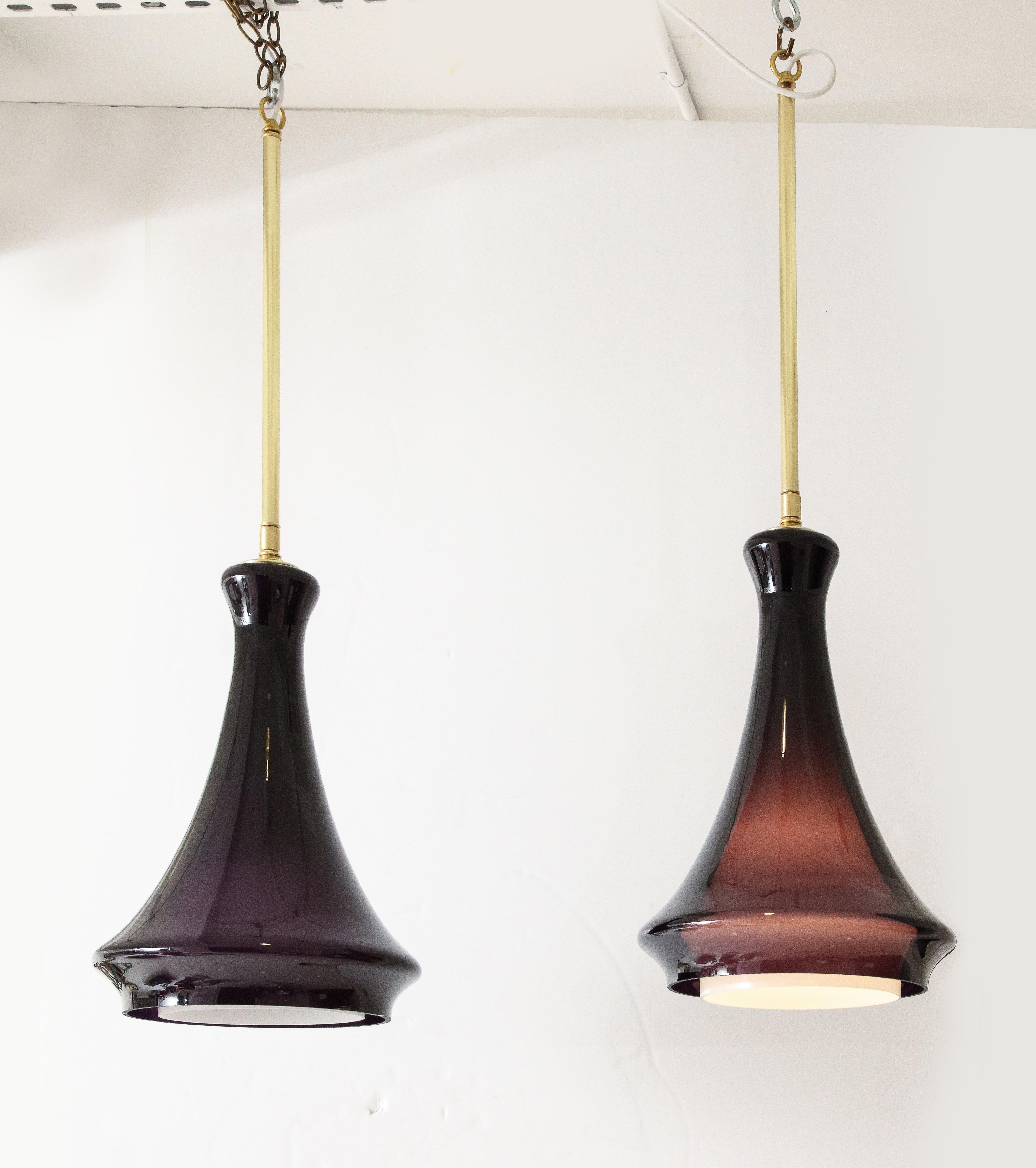 Stunning pair of large glass pendant lights.
Each pendant light  is in two parts  with the Dark Rich Aubergine glass securely sitting over the White milk glass inner shade which are illuminated by a Newly rewired single standard size light